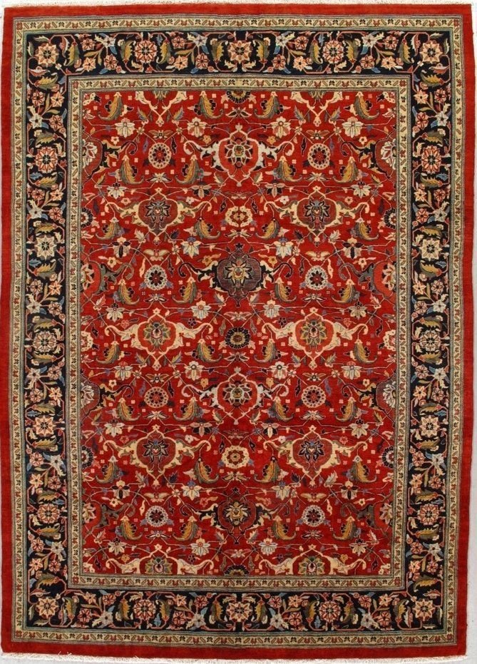 A red rug with a floral pattern on it is on a white surface.