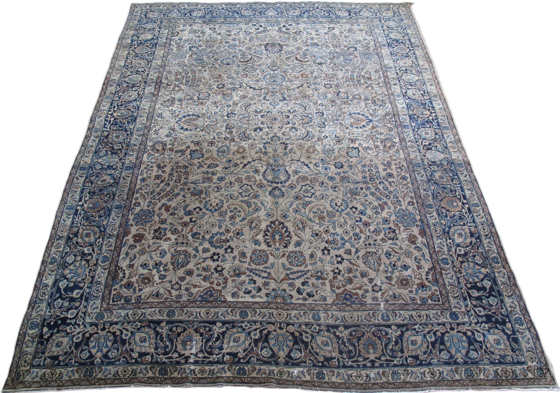 A rug with a floral pattern on it is on a white background.