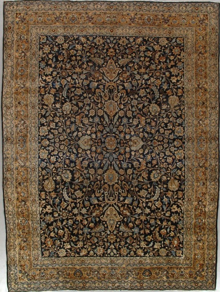 A rug with a floral pattern on it is hanging on a wall.