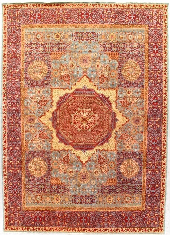 A rug with a circular pattern on it is on a white background.