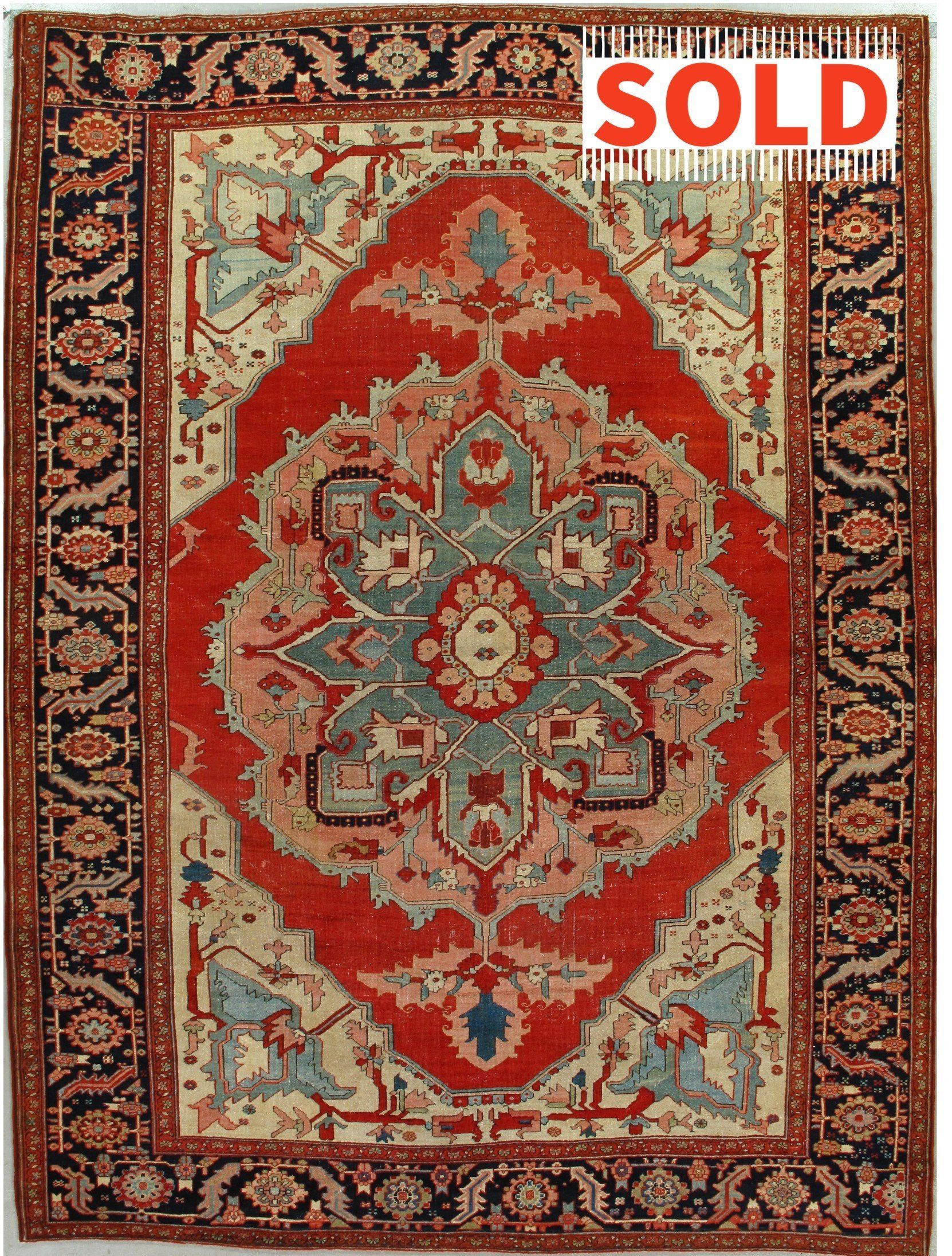 A rug with a sold sign on it is on a white background.