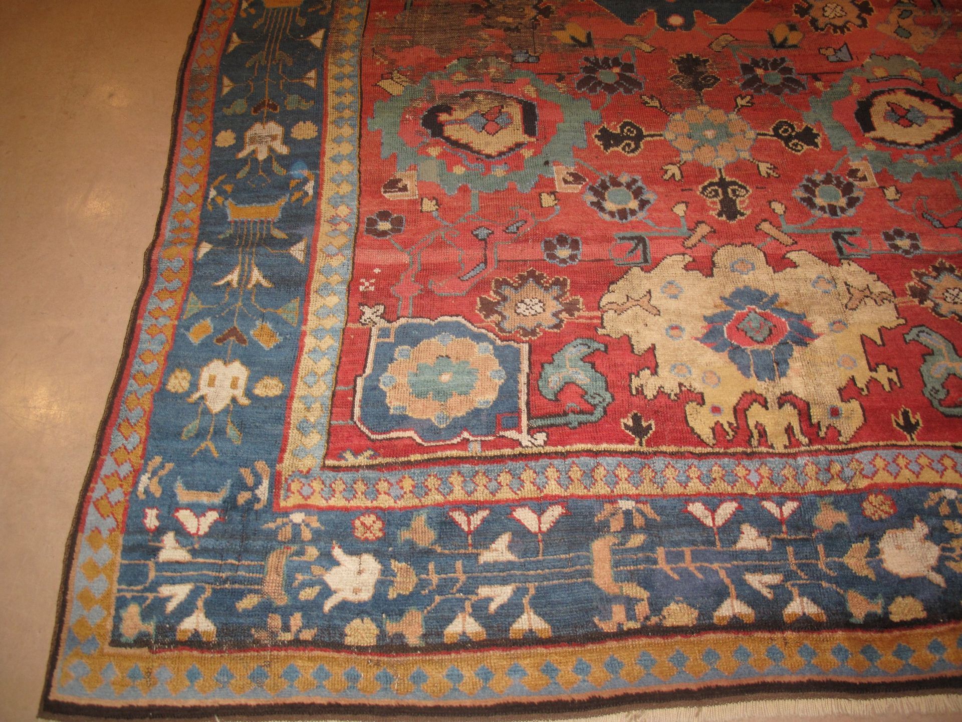 A red and blue rug is laying on the floor