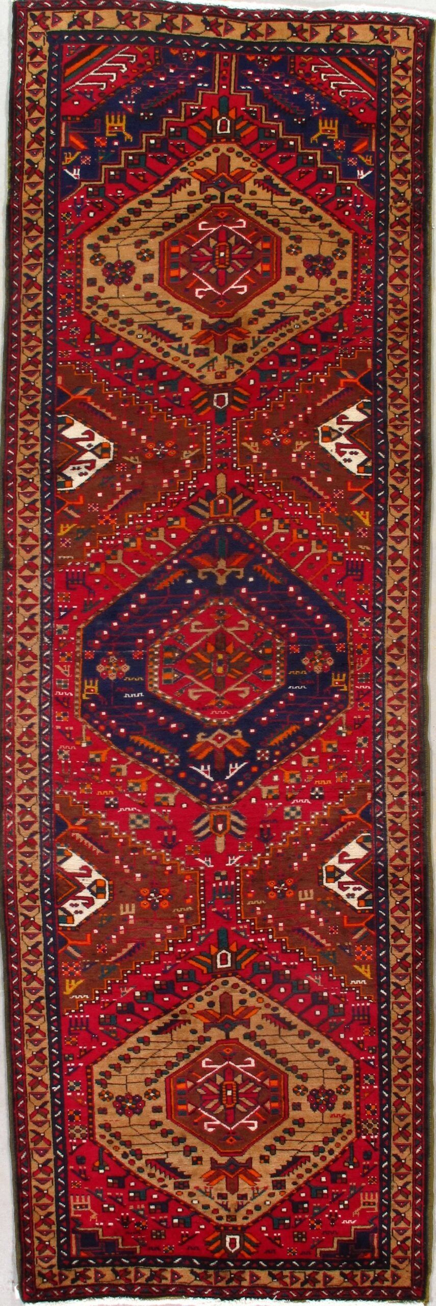 A red rug with a pattern on it is on a white background.