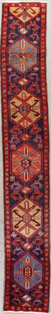 A red and blue rug with a geometric pattern on it