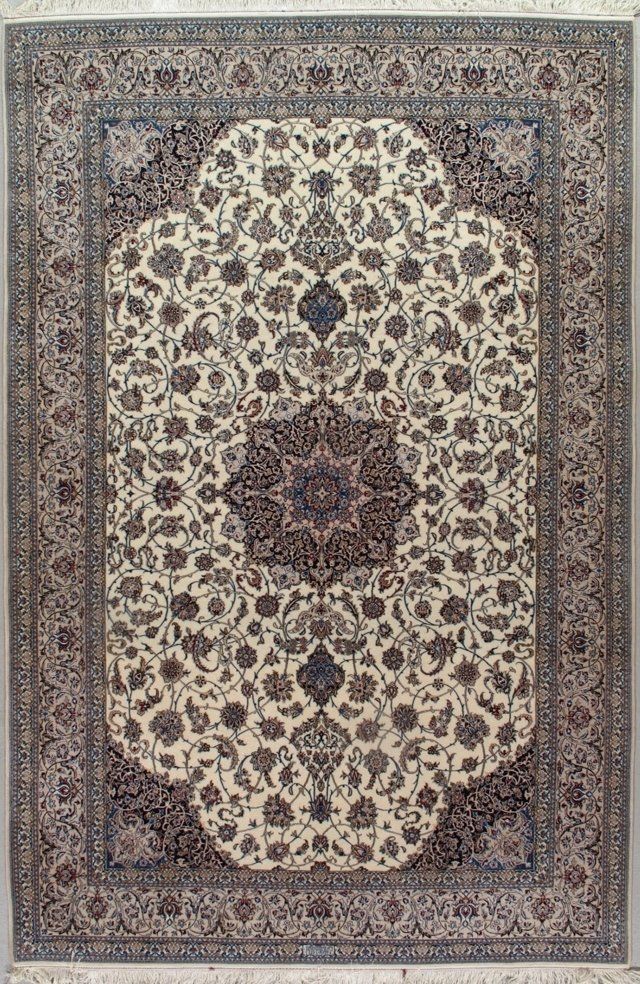 A rug with a floral pattern on it is hanging on a wall.