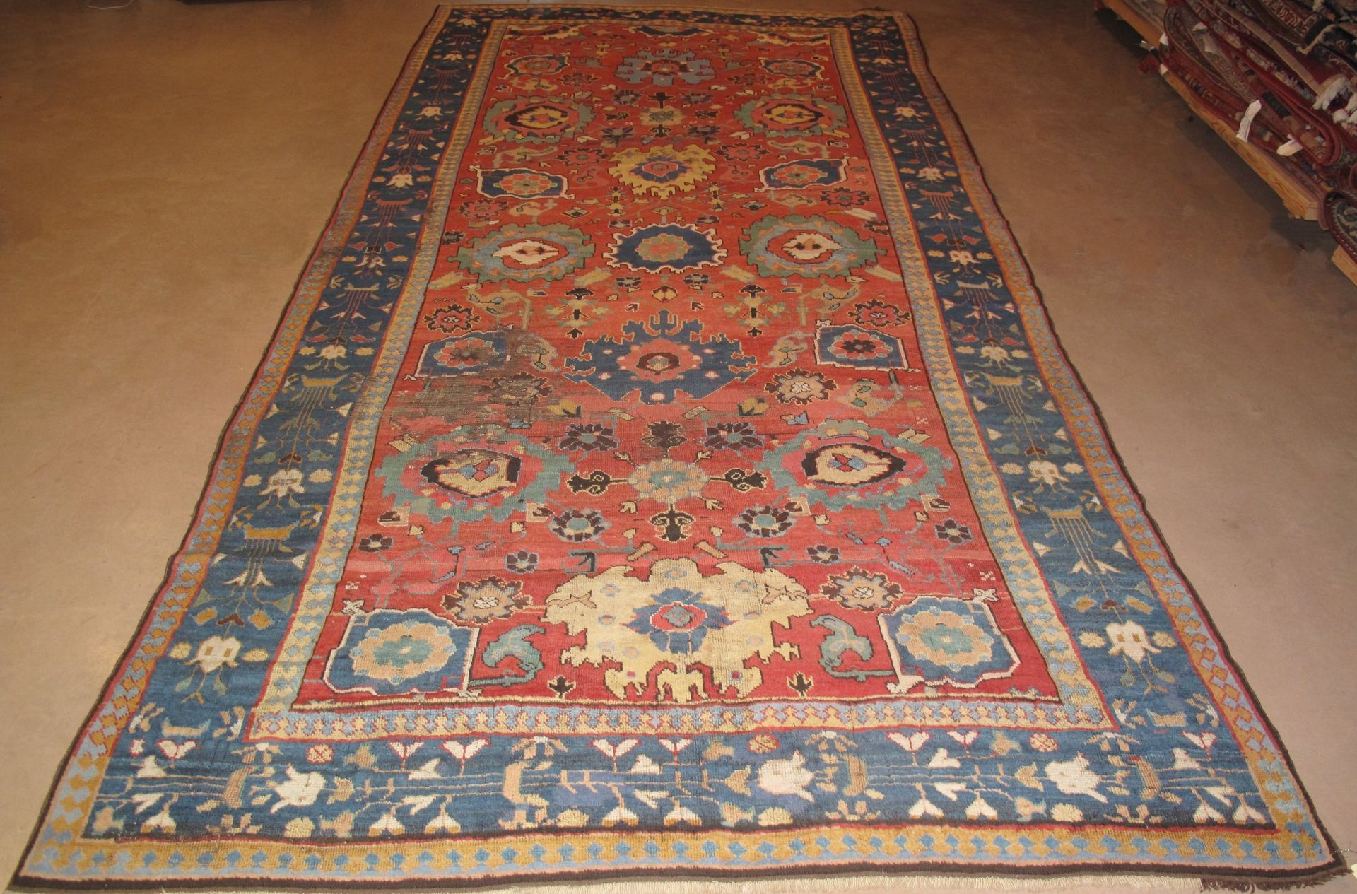 A red and blue rug is laying on the floor