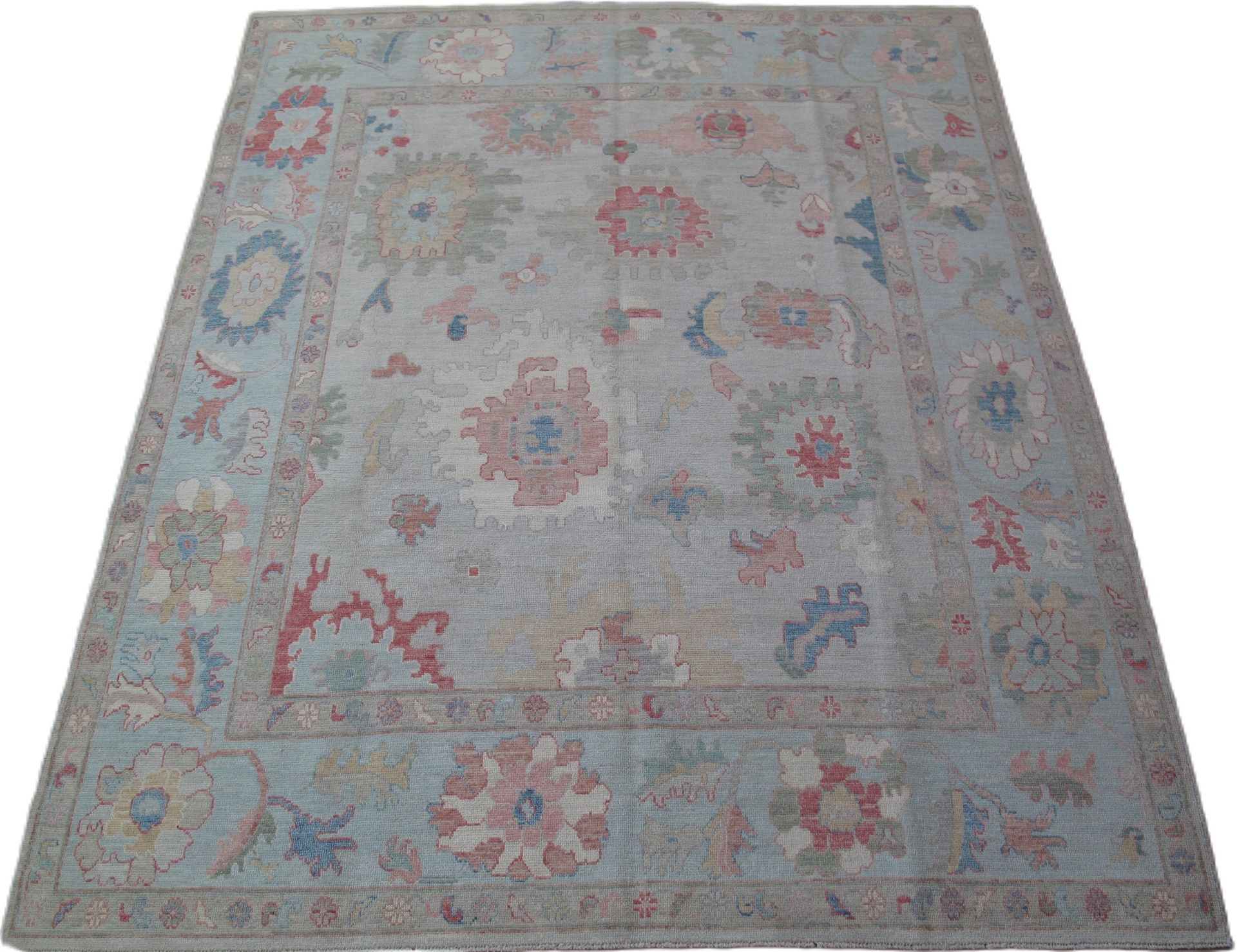 A rug with a pattern of flowers and leaves on it