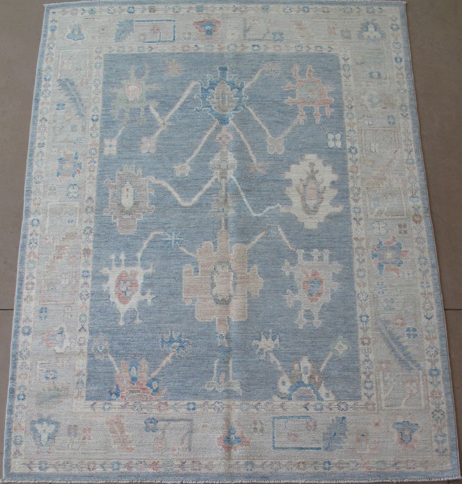 A blue and white rug with a floral pattern on it