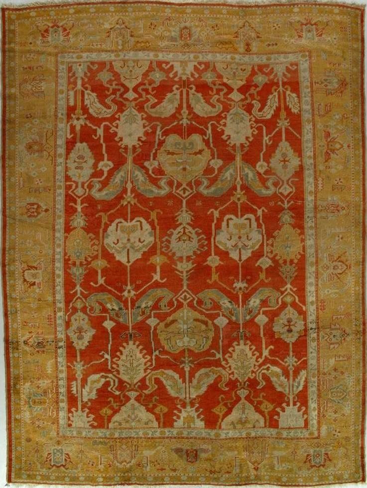 A red and gold rug with a floral pattern on it