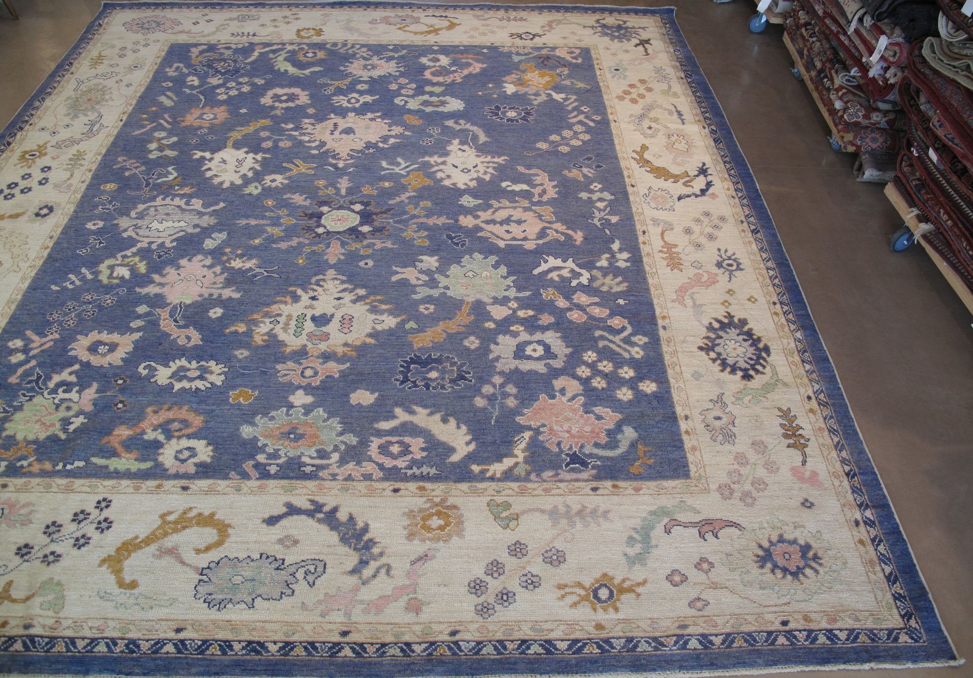 A blue and white rug with a floral pattern on it
