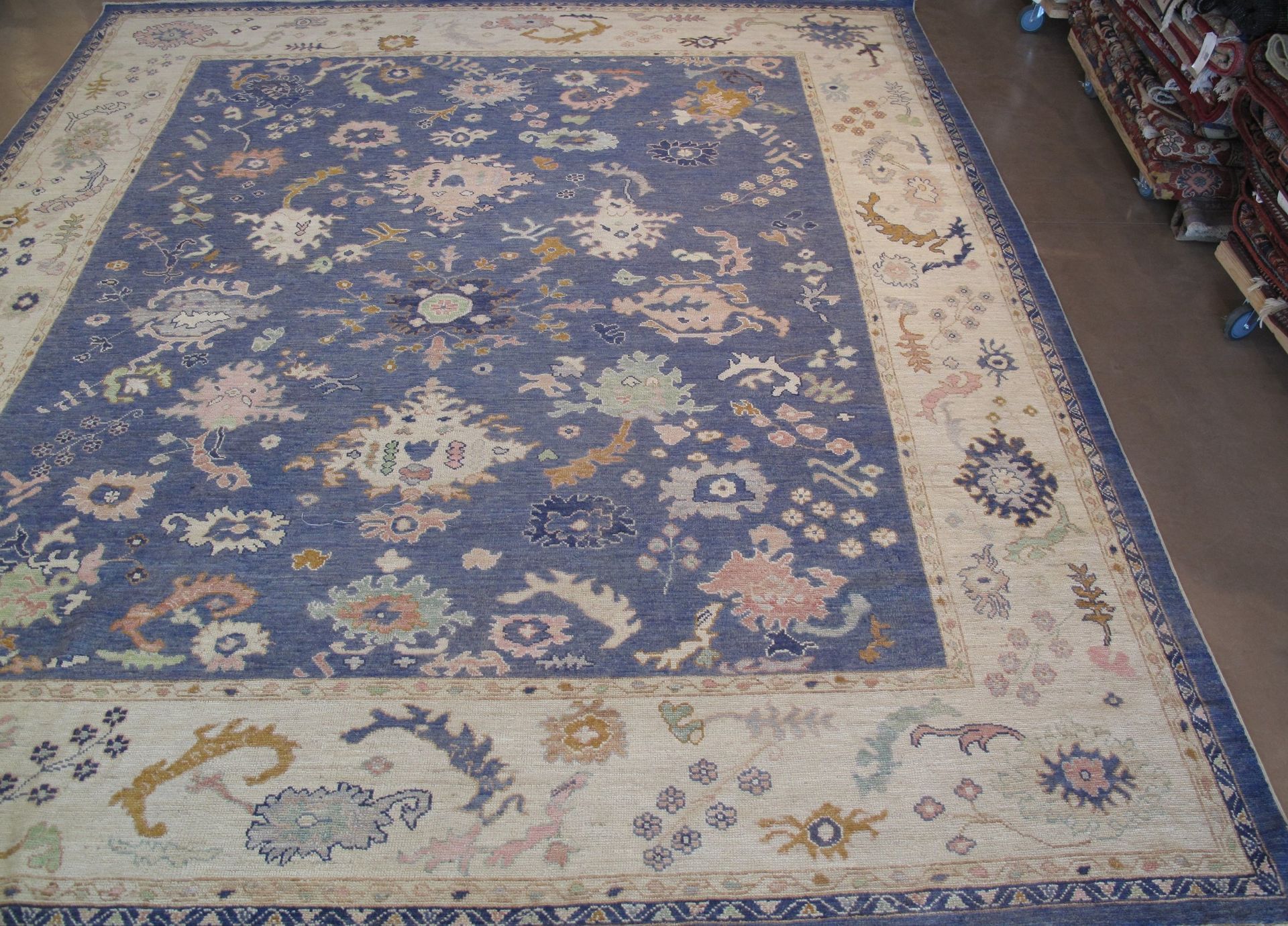 A blue and white rug with a floral pattern on it