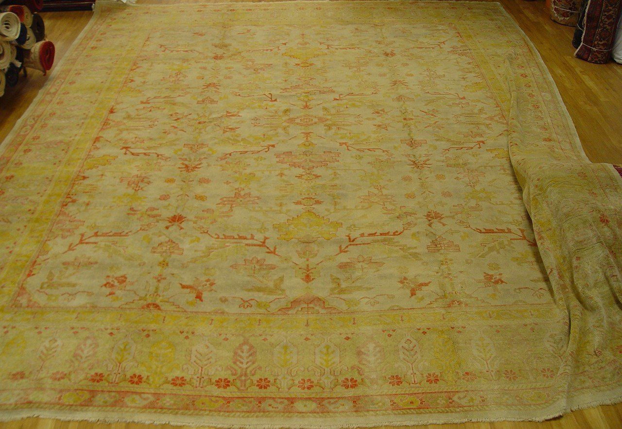 A close up of a rug with a floral pattern on a white surface.