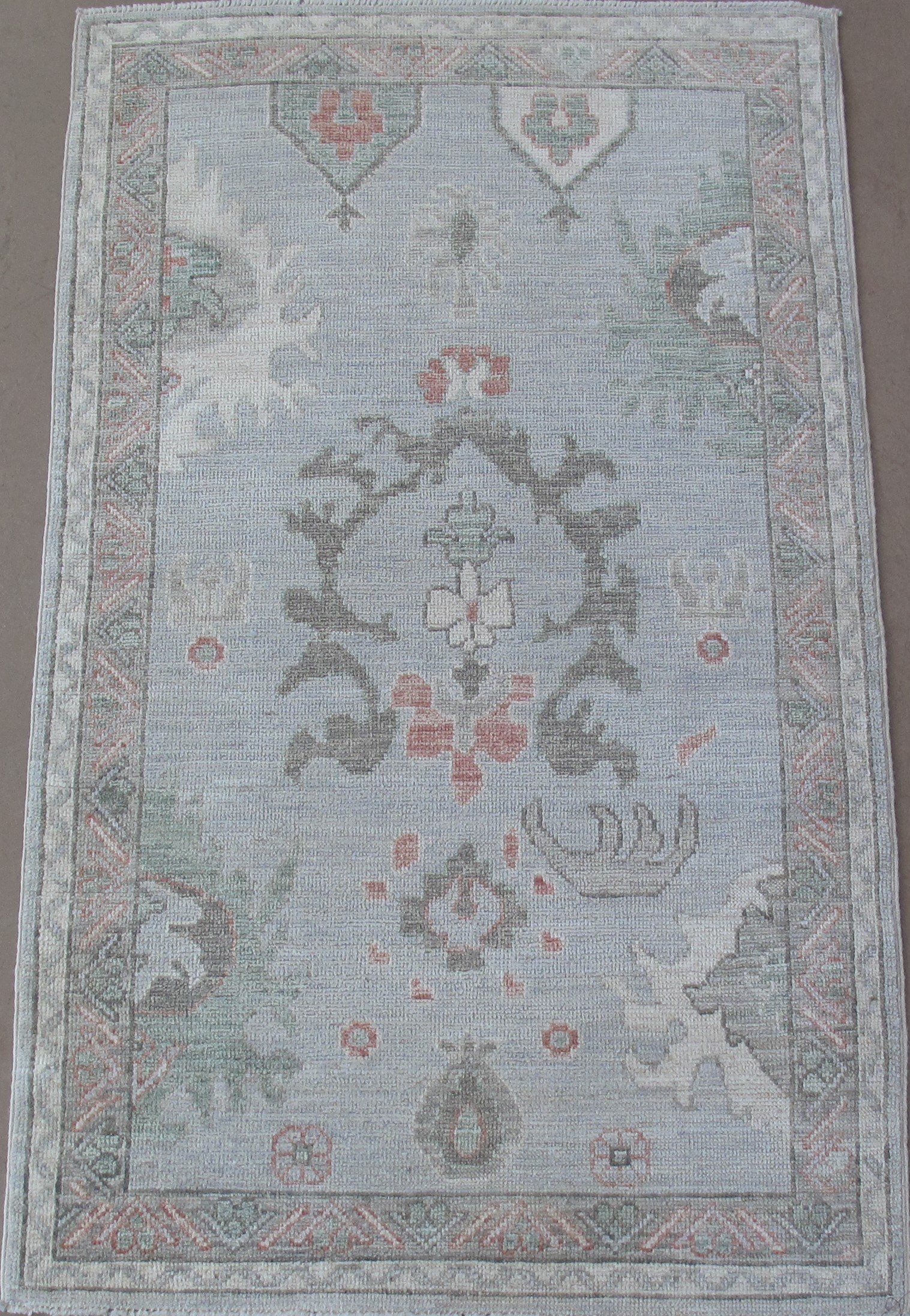 A rug with a floral pattern on it is sitting on a table.
