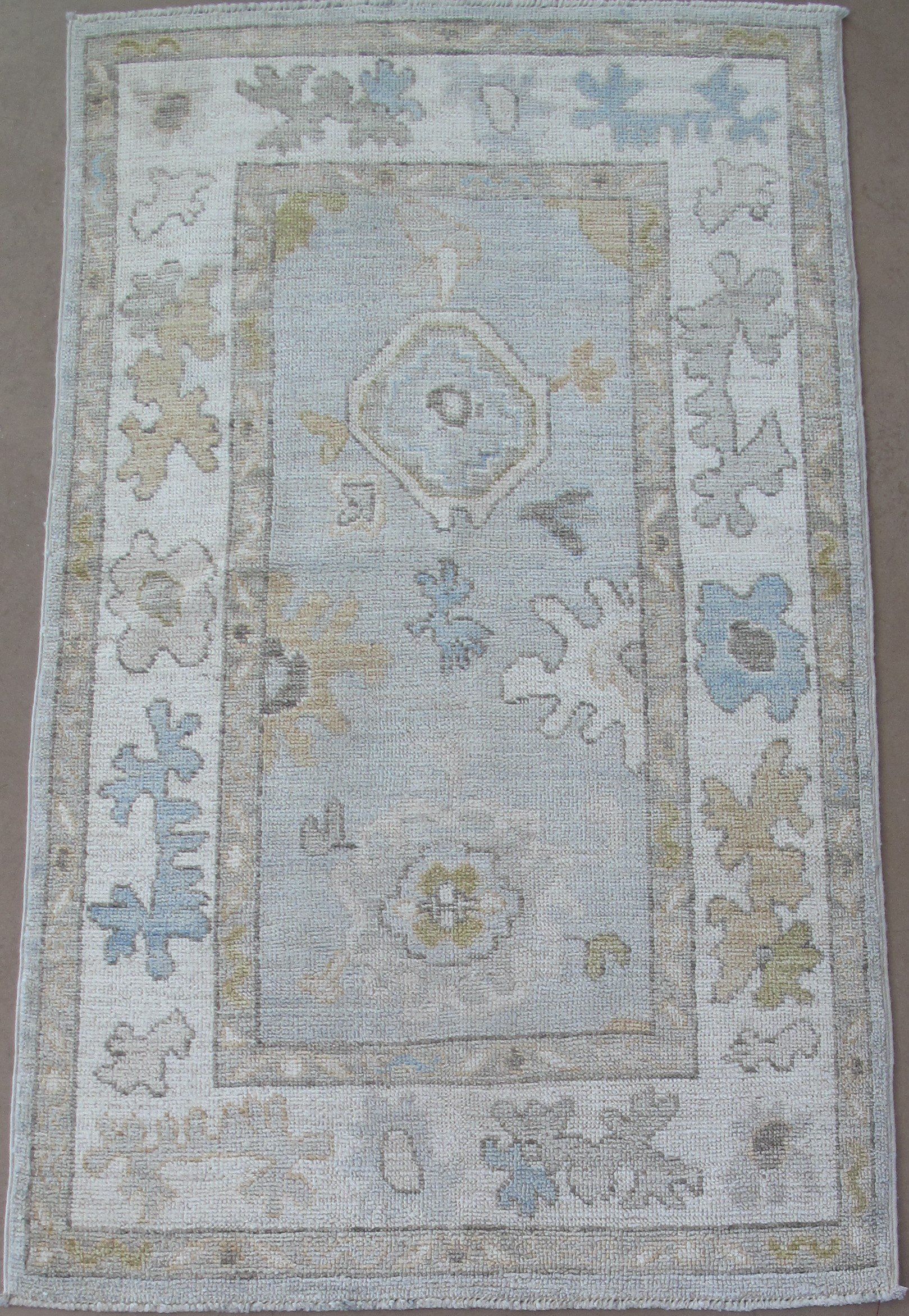 A rug with a floral pattern is sitting on a table.