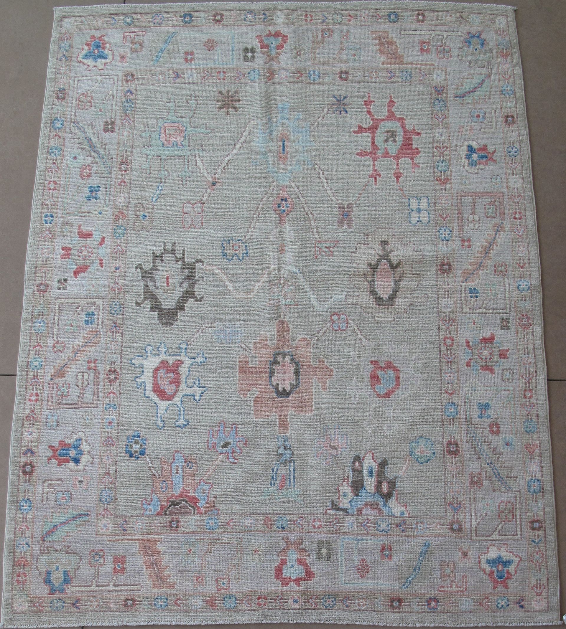 A rug with a floral pattern is sitting on a table.