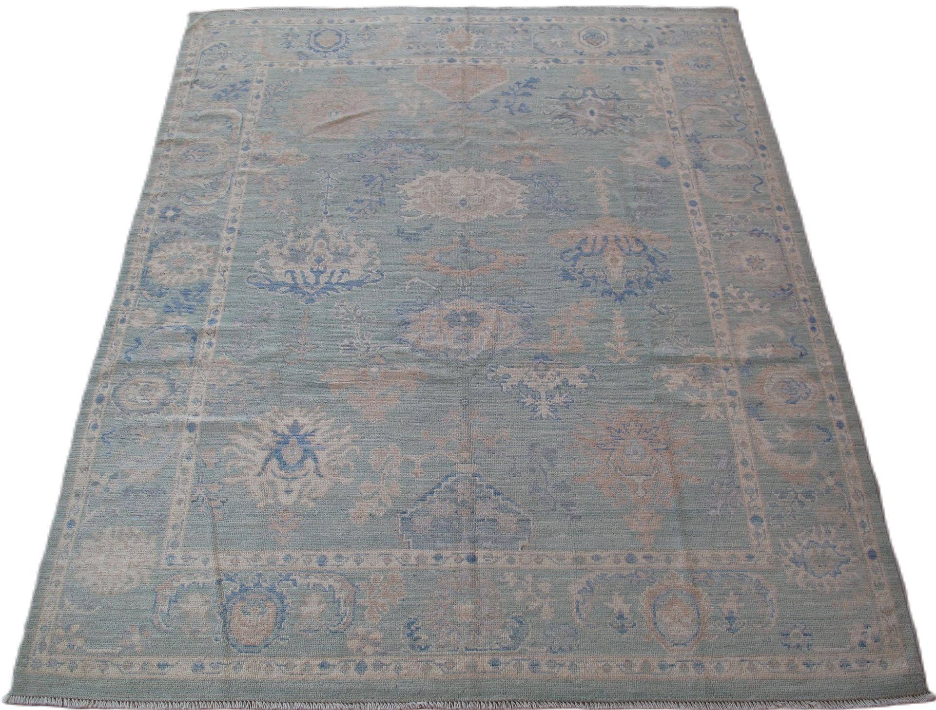 A rug with a pattern on it is sitting on a white surface.