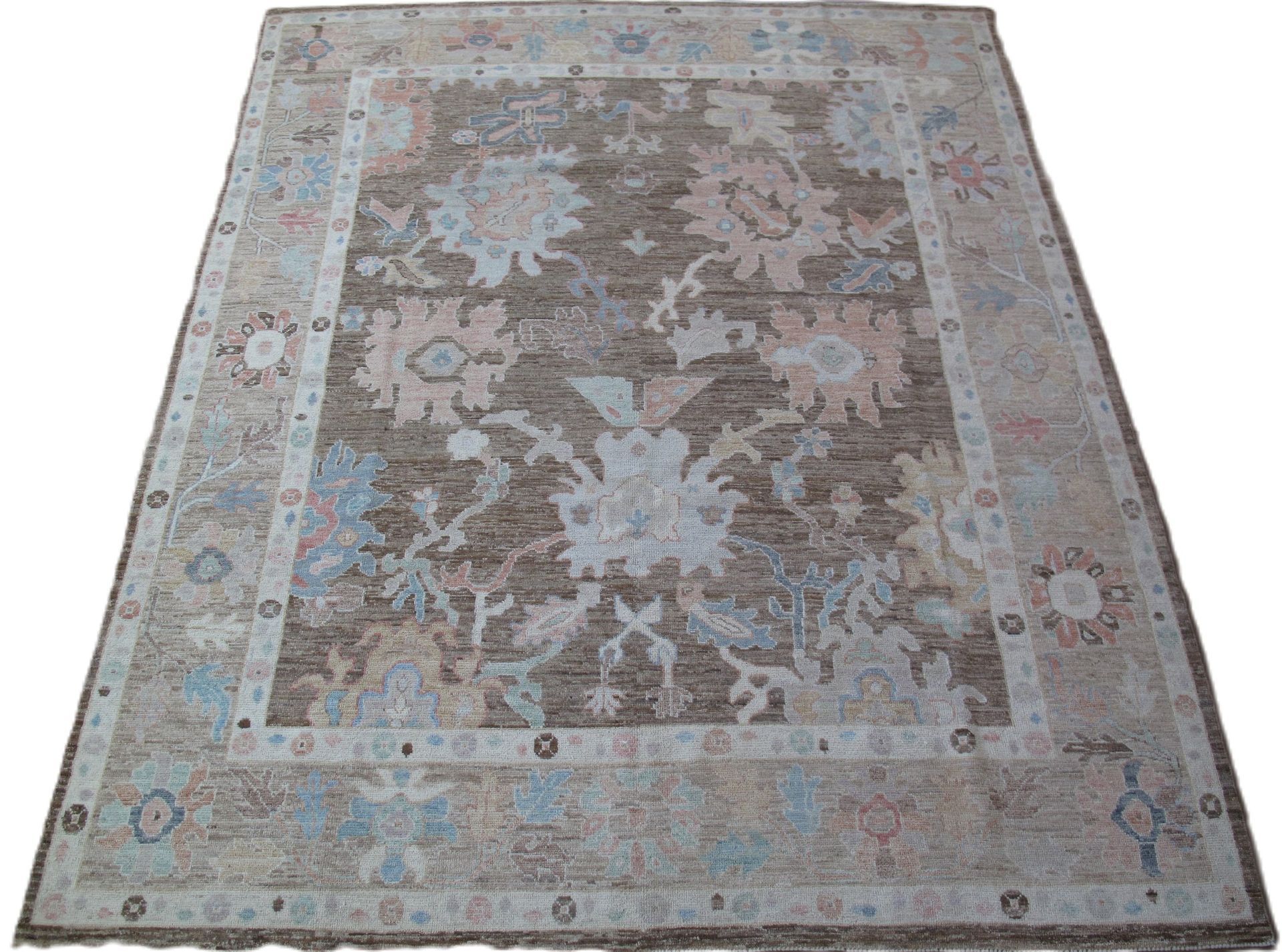 A rug with a floral pattern on it is on a white background.