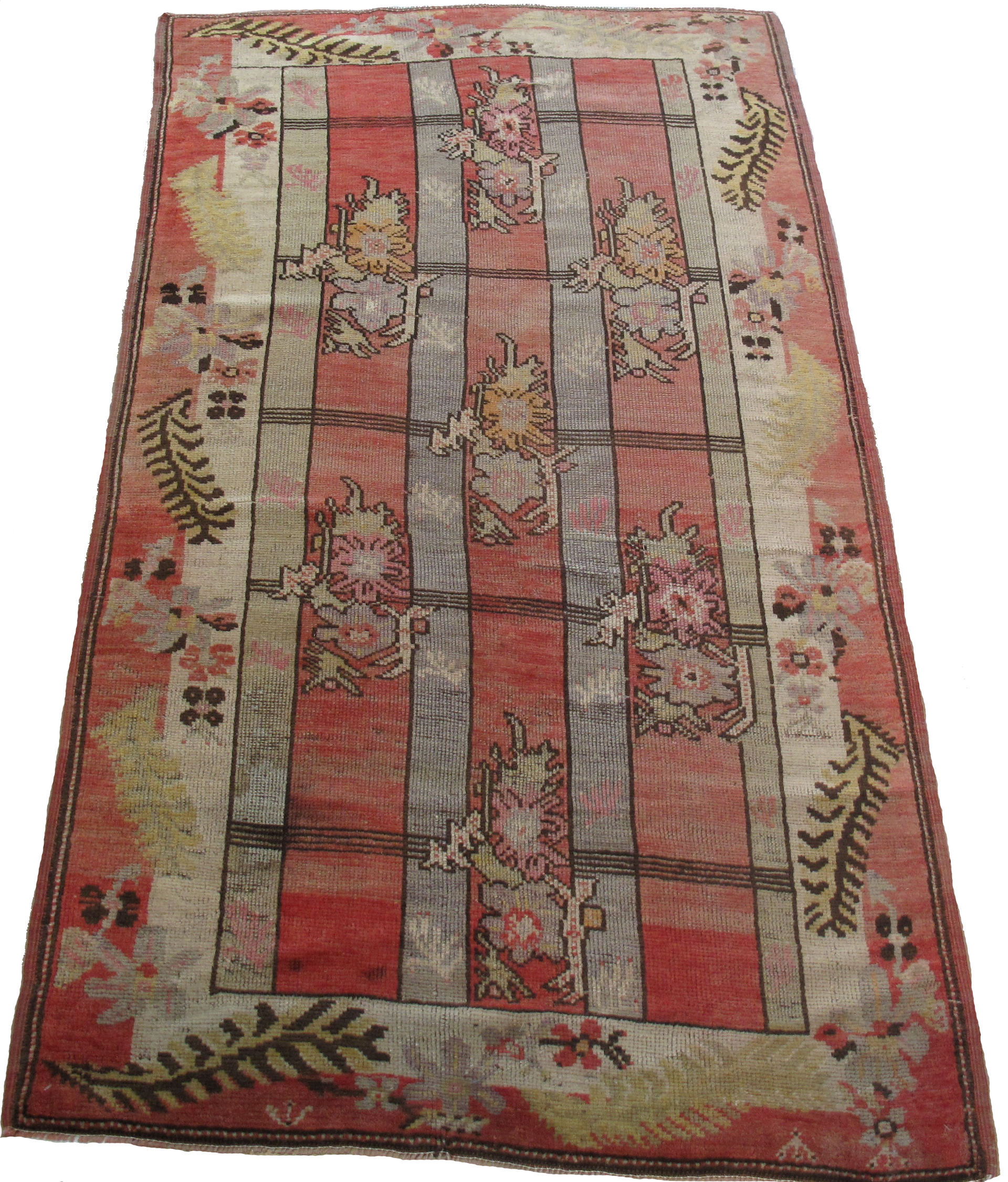 A red rug with flowers and leaves on it