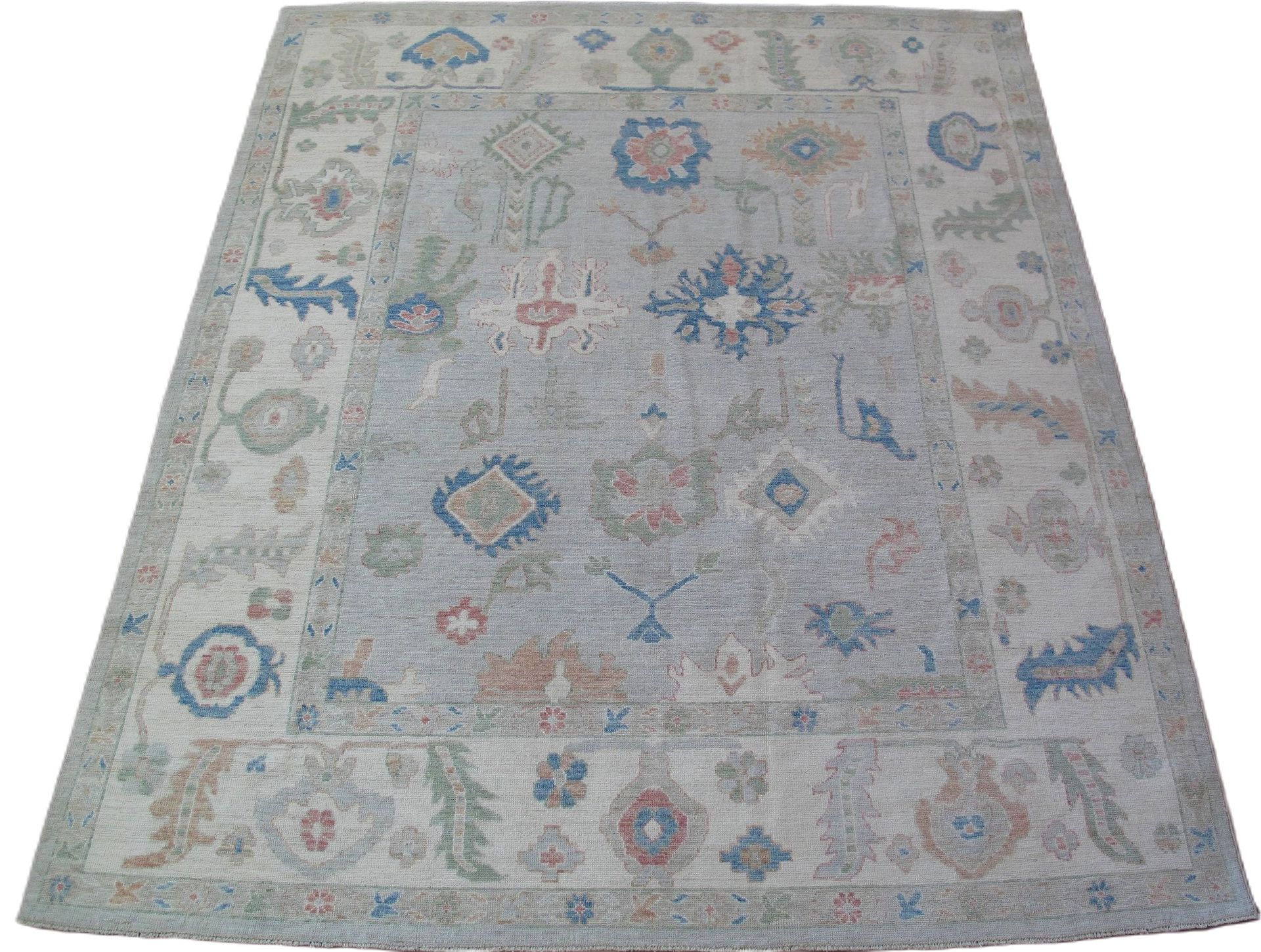A white rug with a floral pattern on it