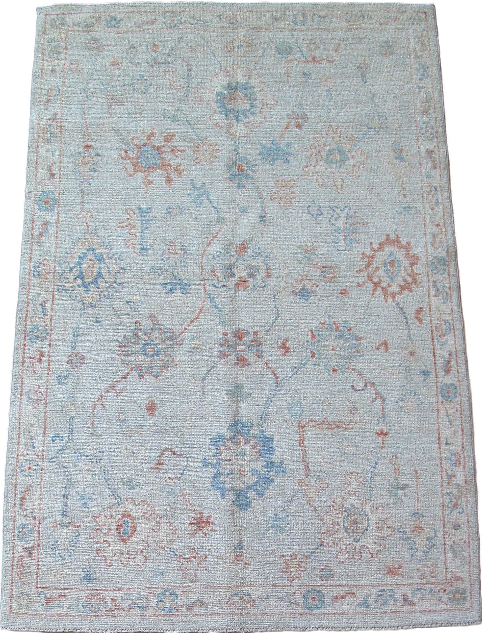 A white rug with a floral pattern on it