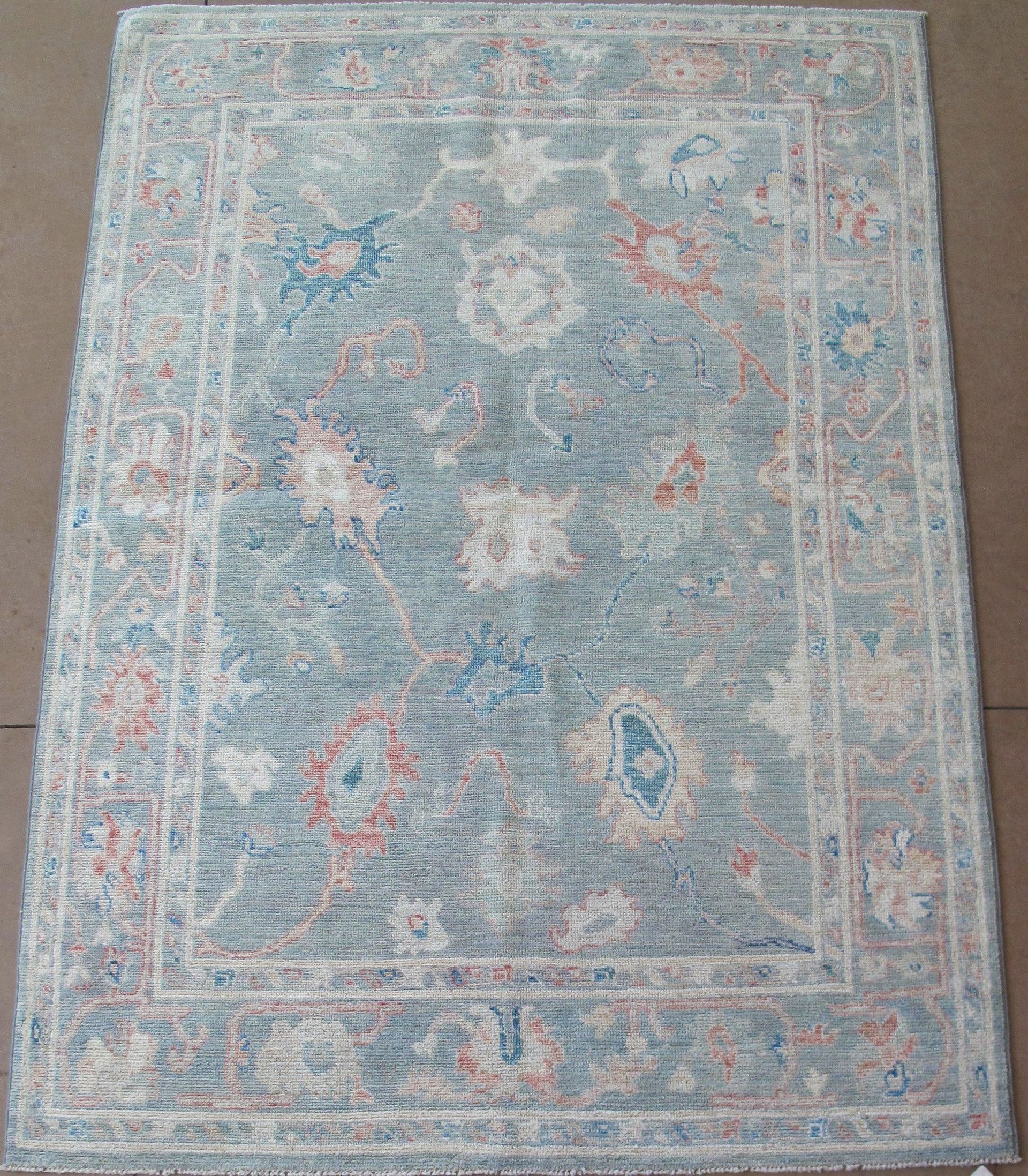 A rug with a floral pattern is sitting on a table.