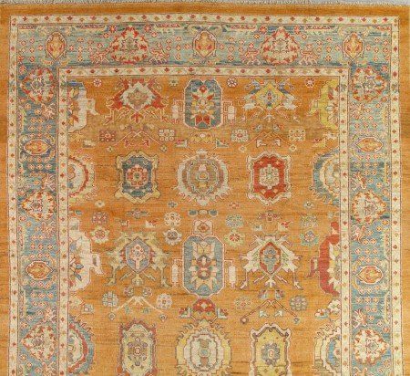 A rug with a pattern on it is on a wooden floor.