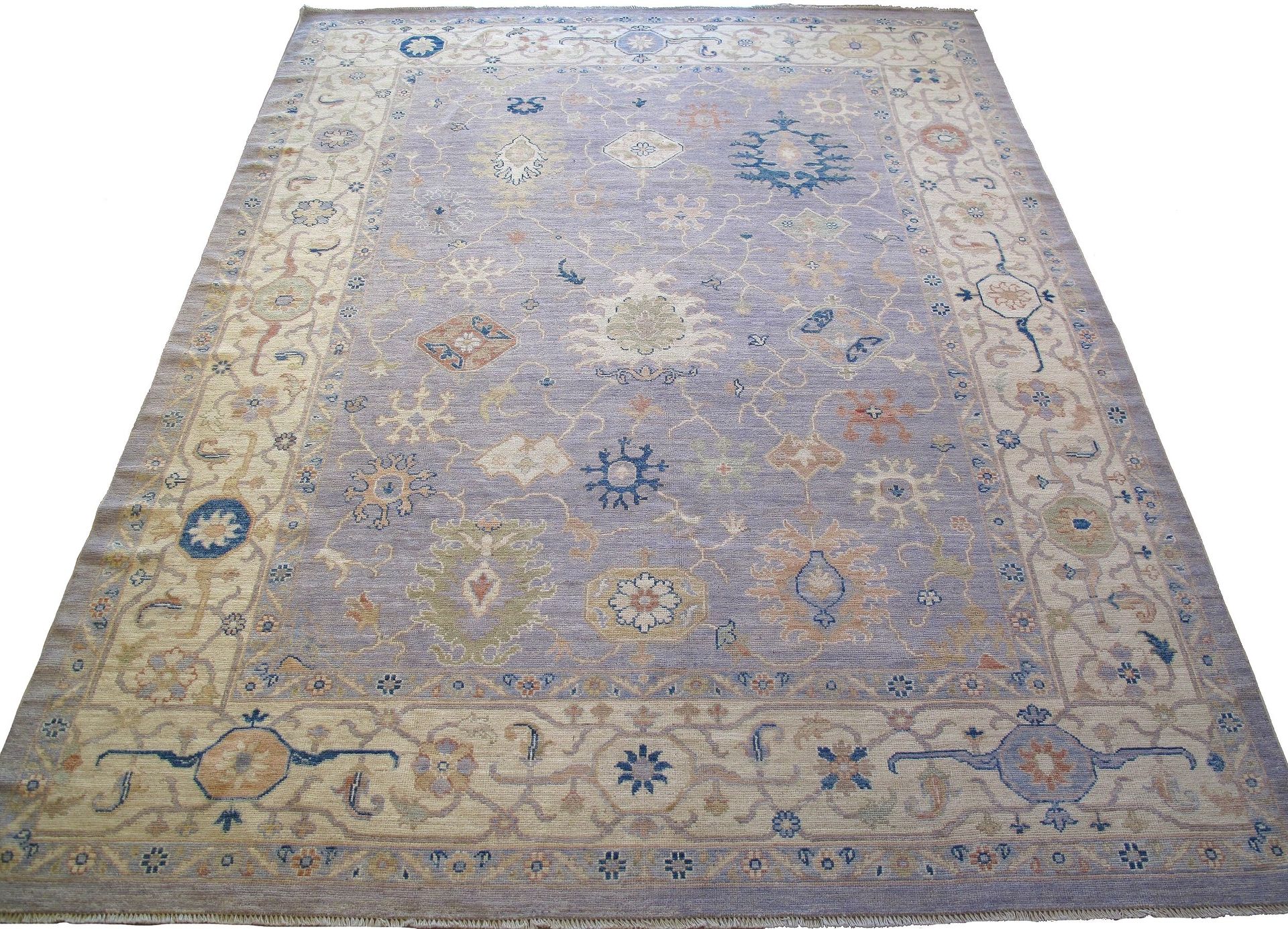 A rug with a floral pattern on it is on a white background.