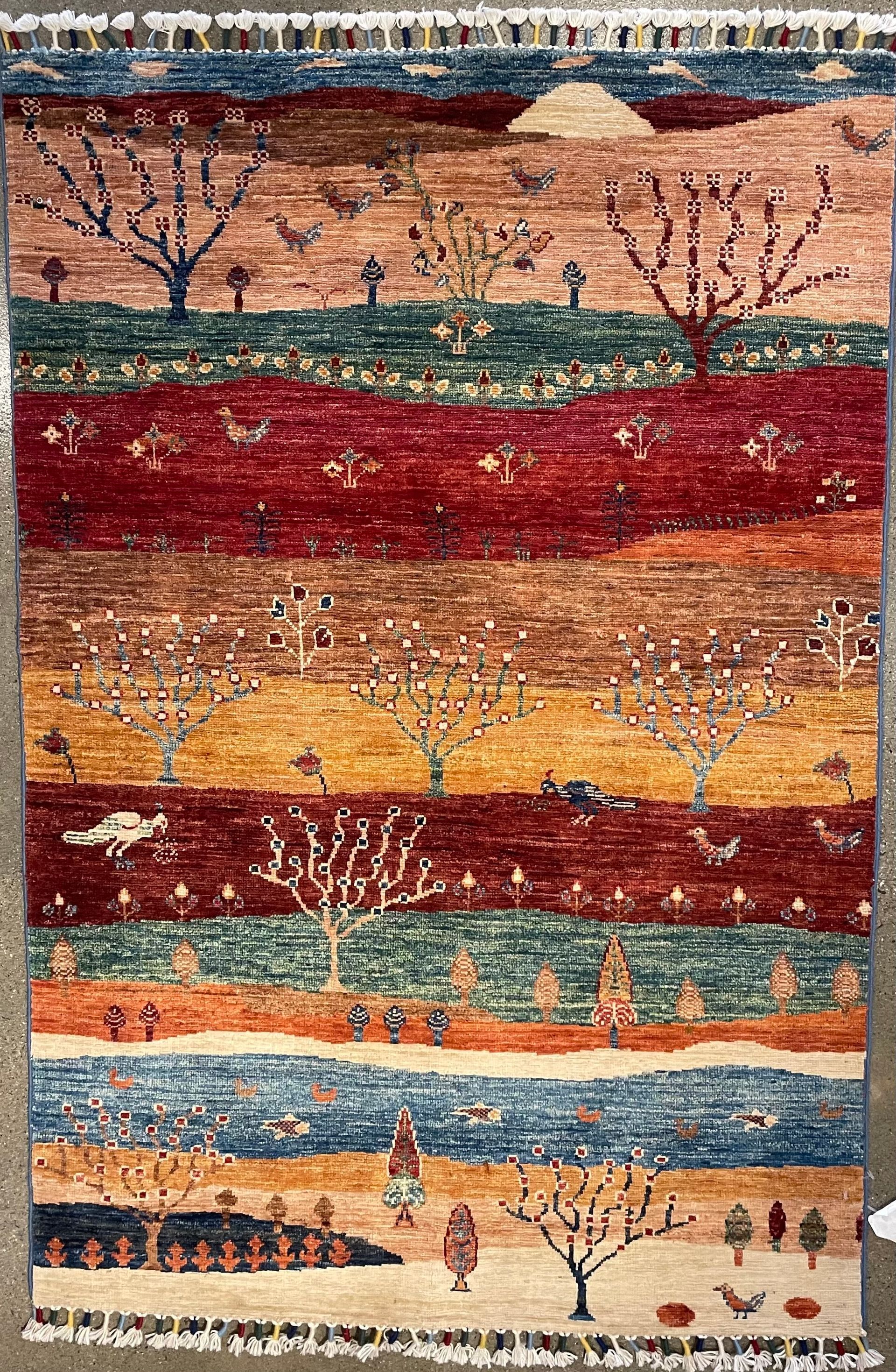 A rug with a landscape on it is sitting on a table.