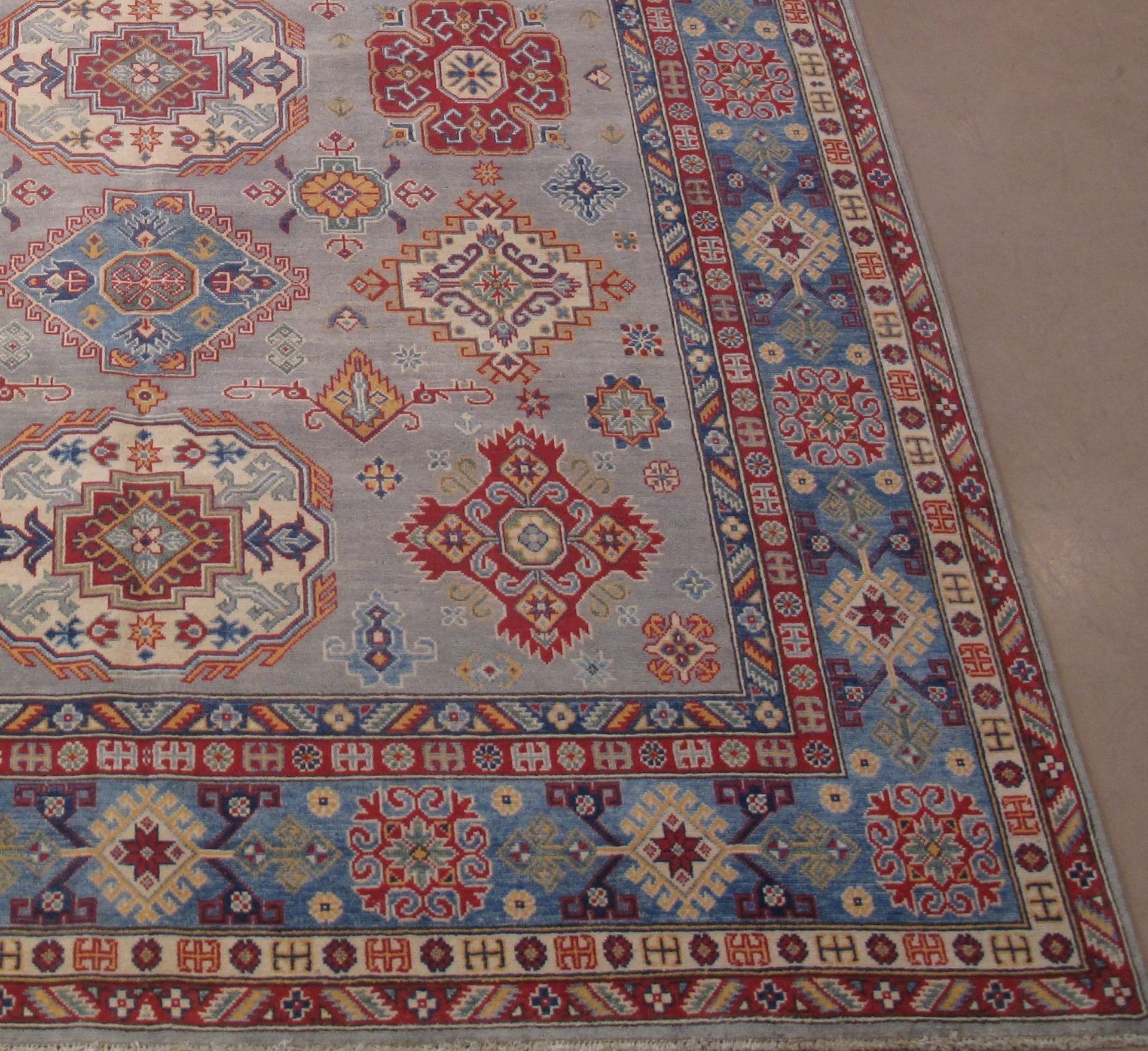 A rug with a pattern on it is sitting on a floor.