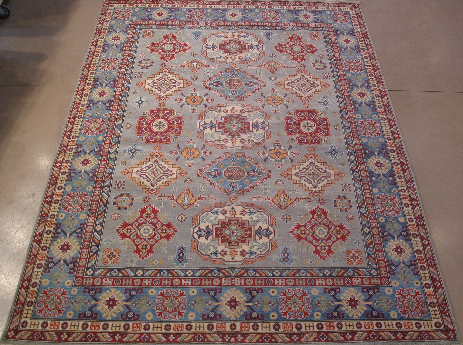 A rug with a pattern on it is sitting on a floor.
