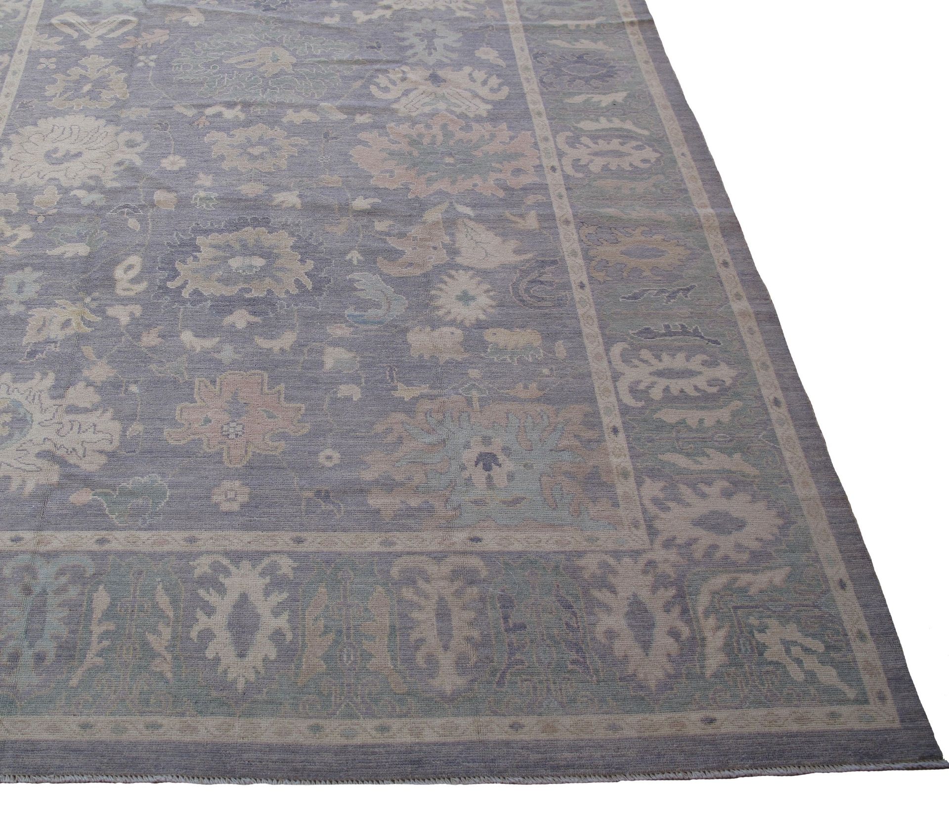 A rug with a floral pattern on it is on a white background.
