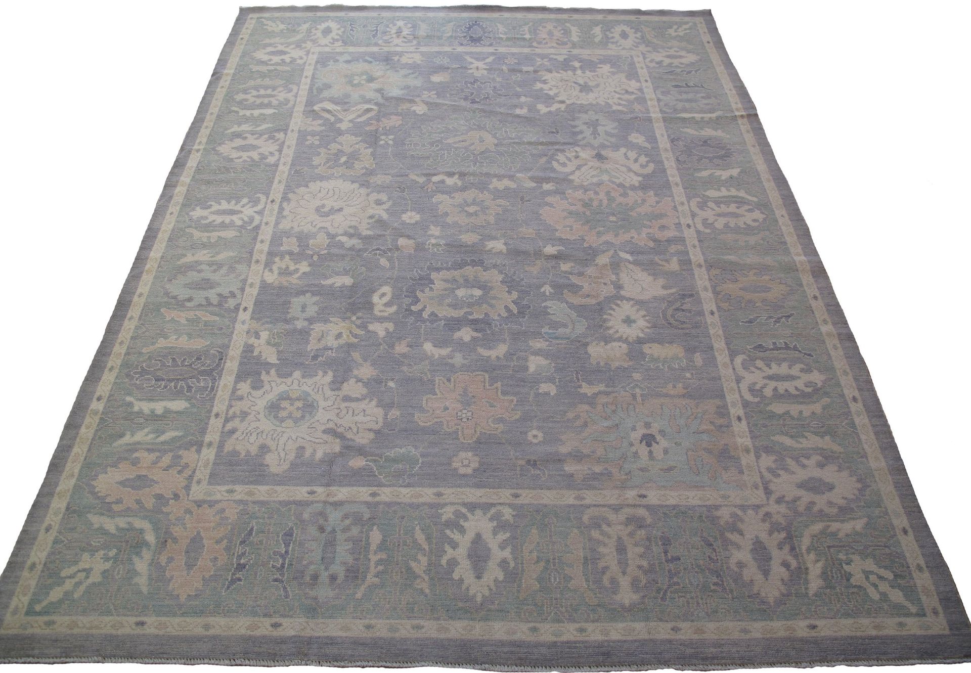 A rug with a floral pattern on it is on a white background.