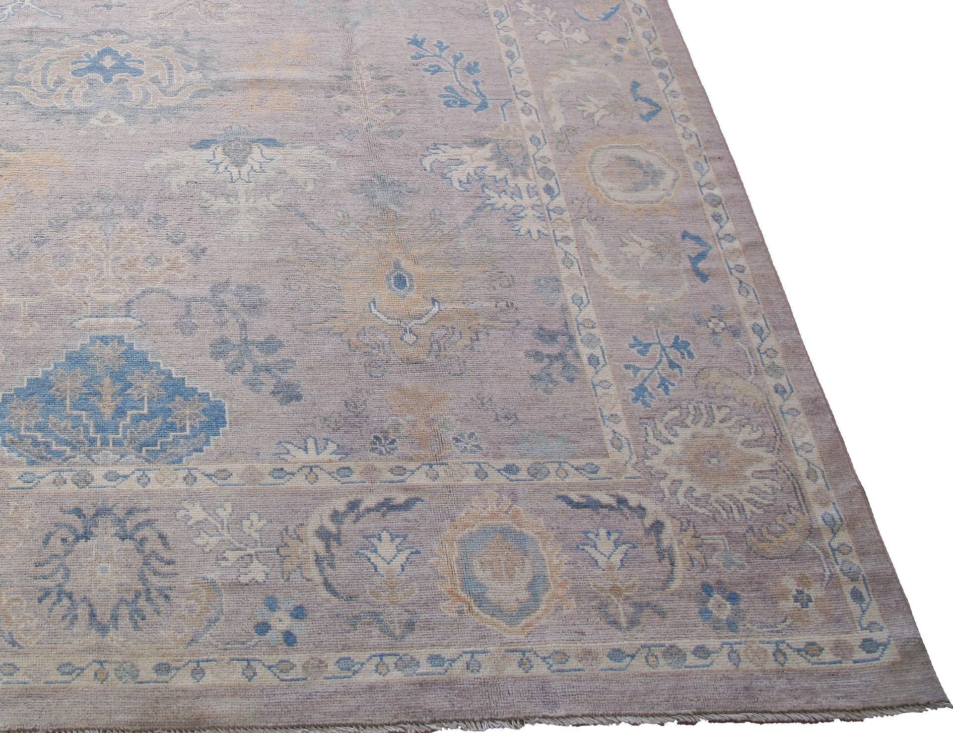 A large rug with a floral pattern is sitting on a white surface.