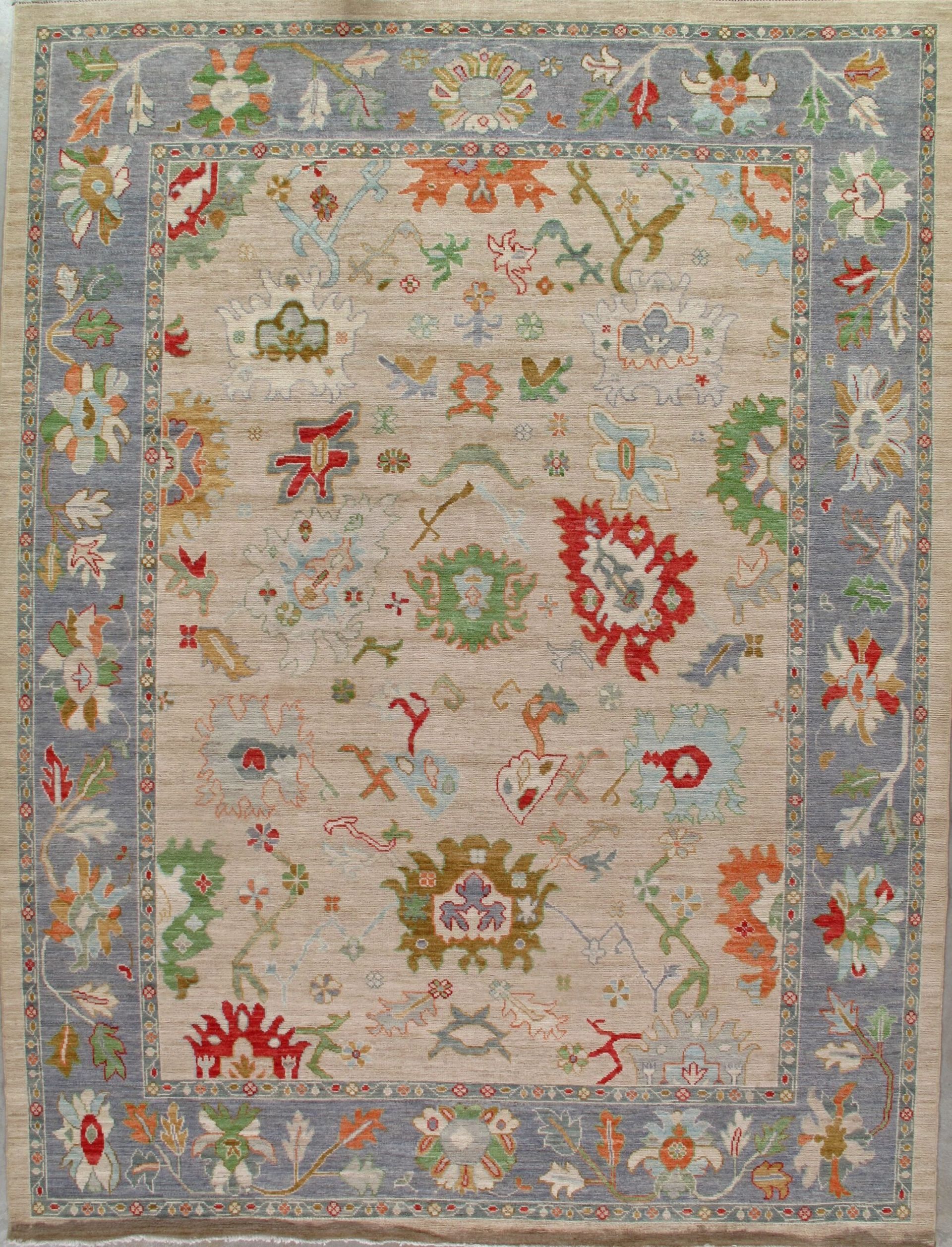 A rug with a floral pattern on it is hanging on a wall.