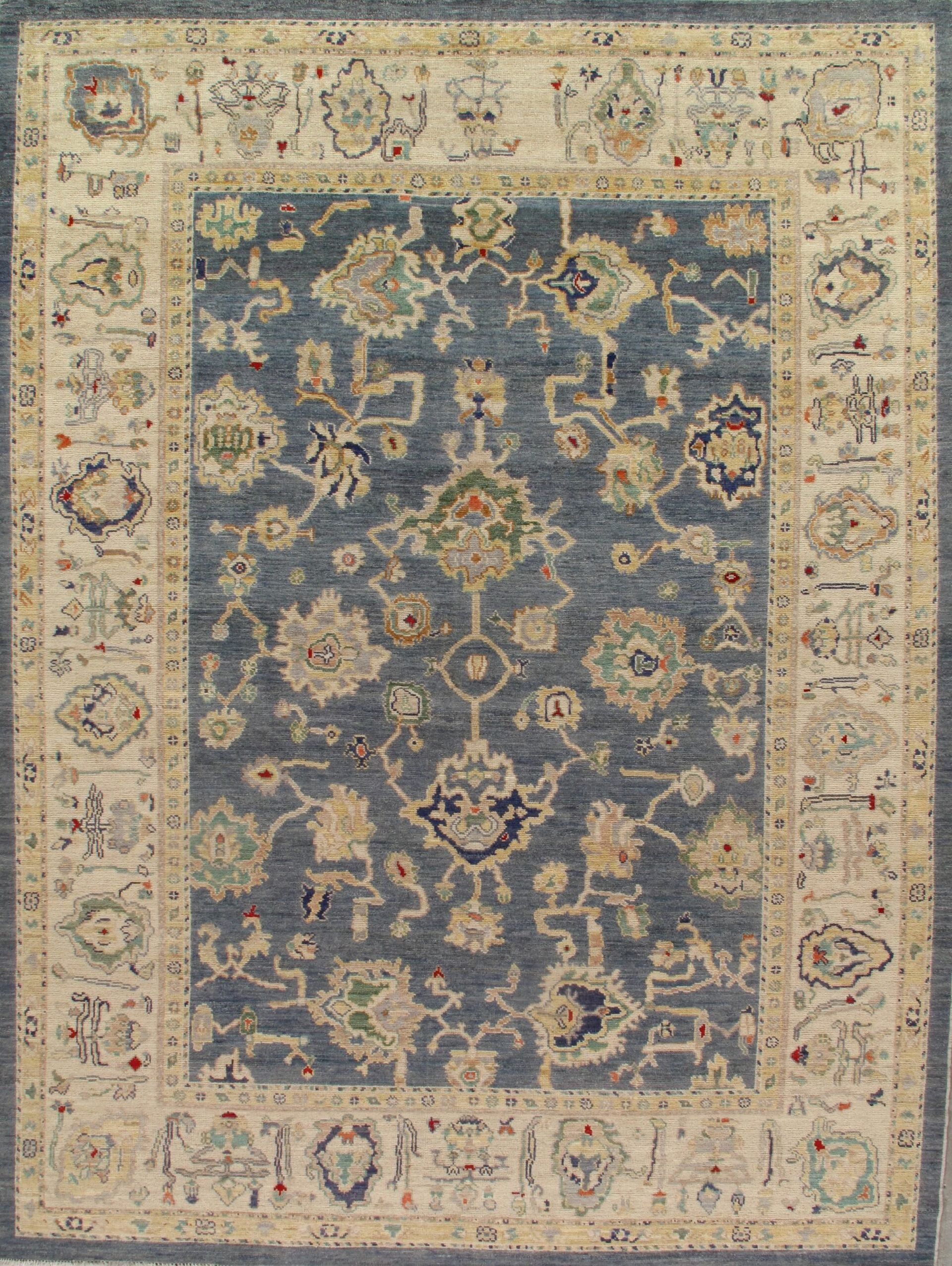 A blue and beige rug with a floral pattern on it.