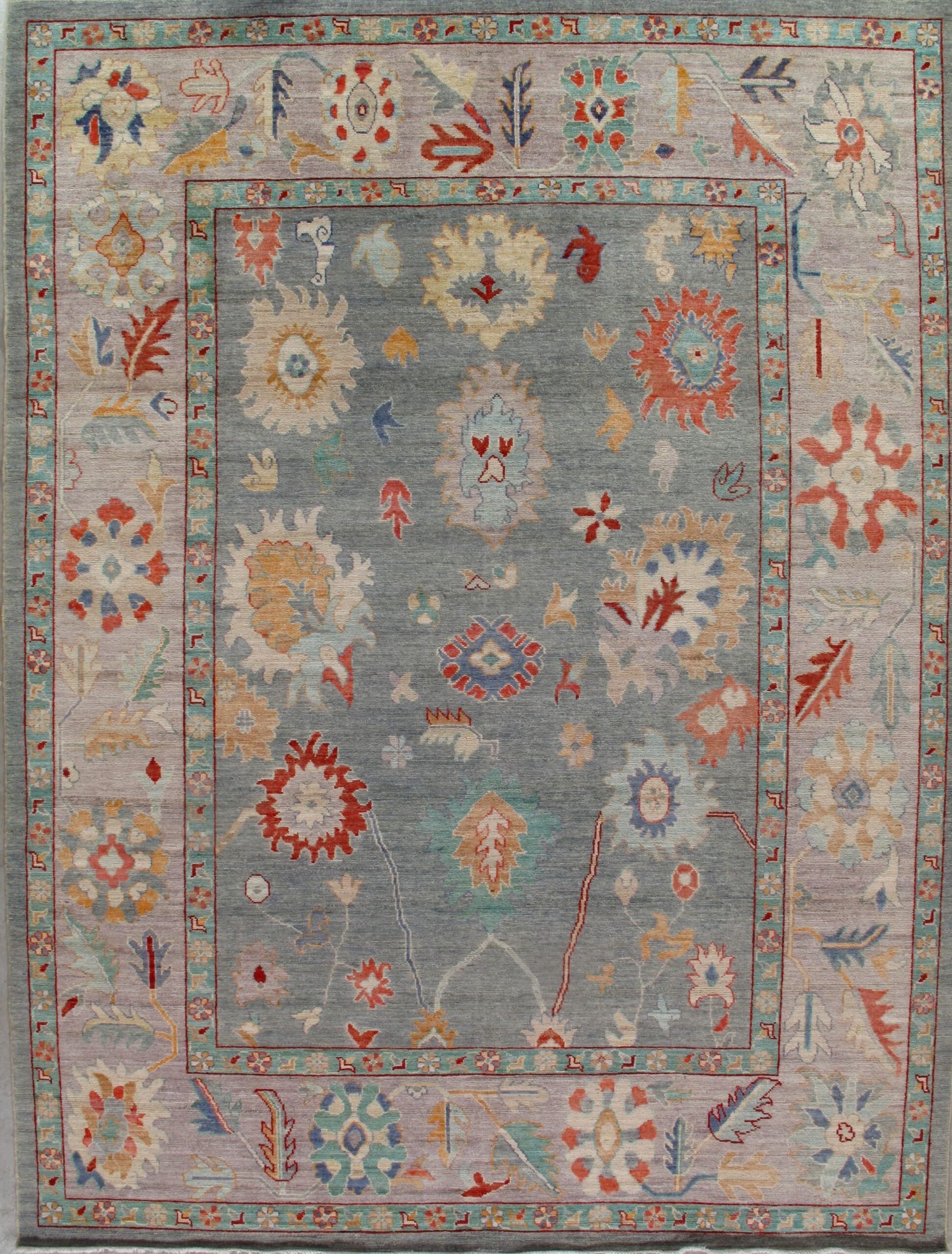 A rug with a floral pattern on it is hanging on a wall.