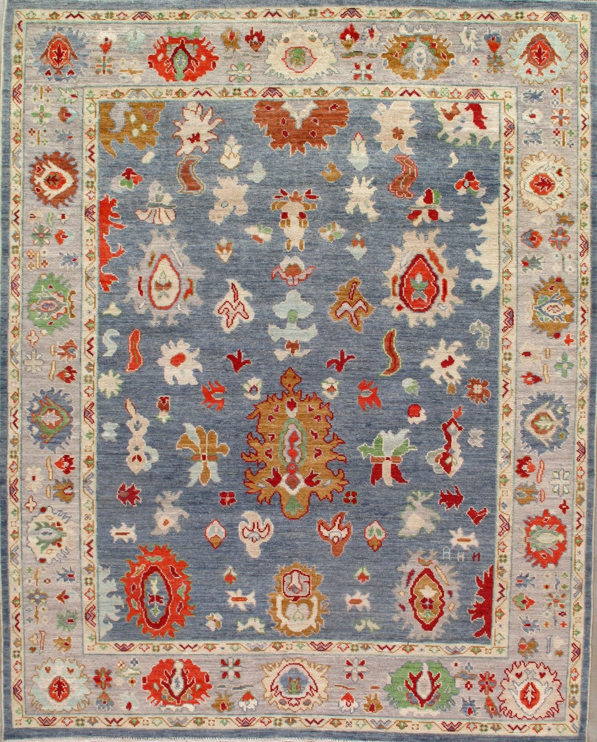 A blue rug with a floral pattern on it