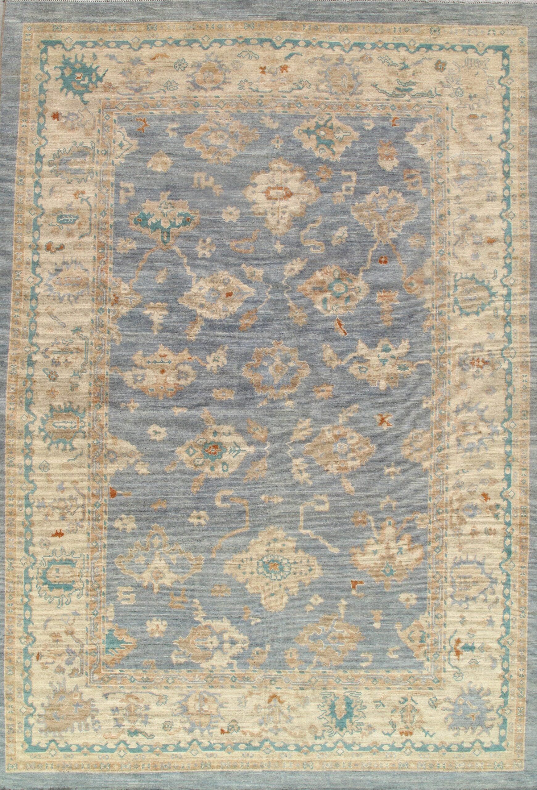 A blue and beige rug with a floral pattern on it.
