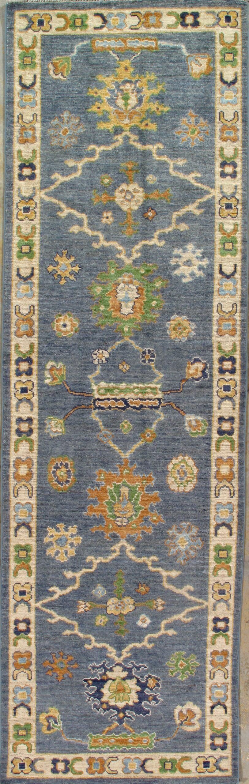 A blue rug with a floral pattern on it is sitting on a table.