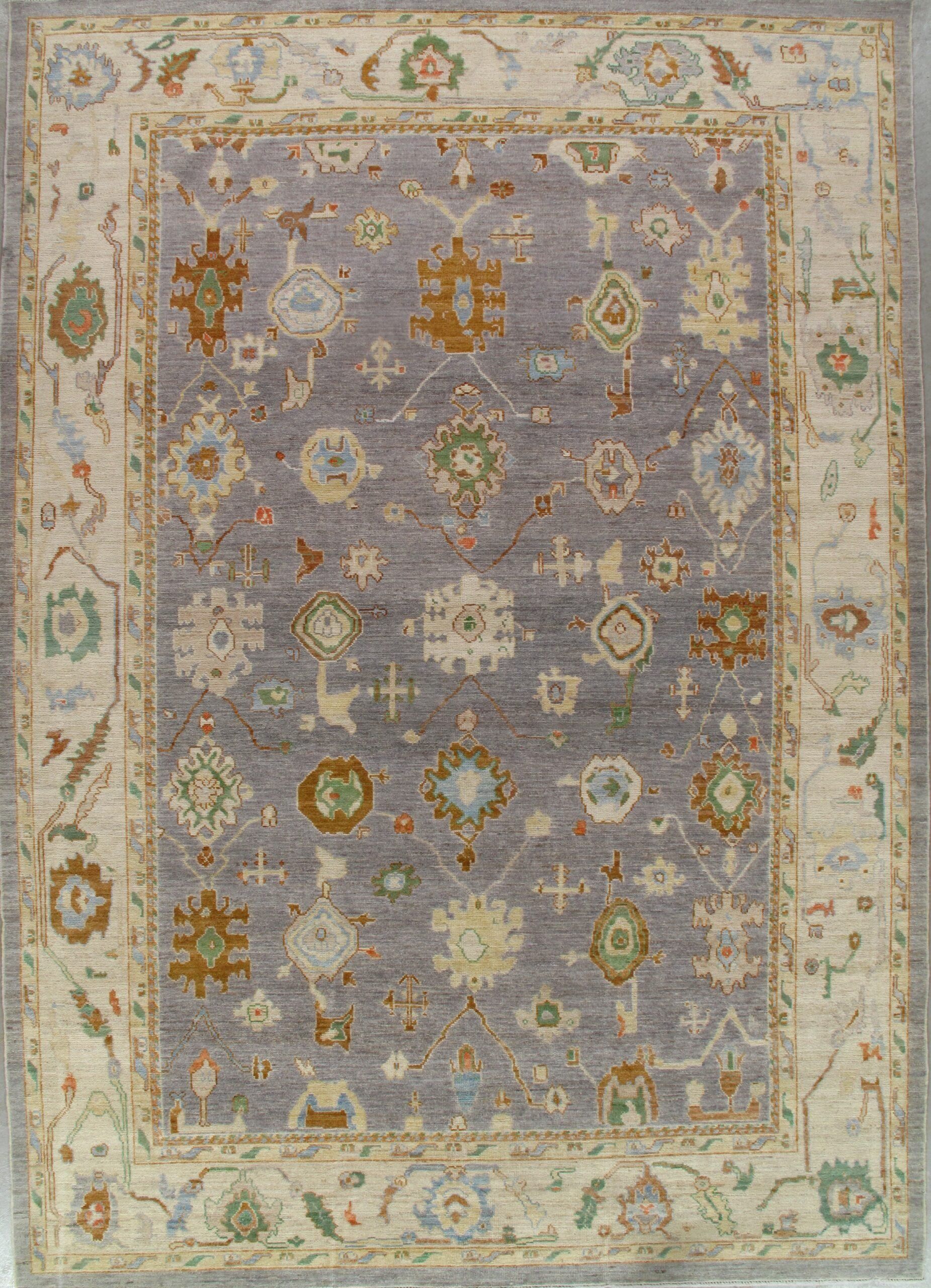 A rug with a floral pattern on it is hanging on a wall.