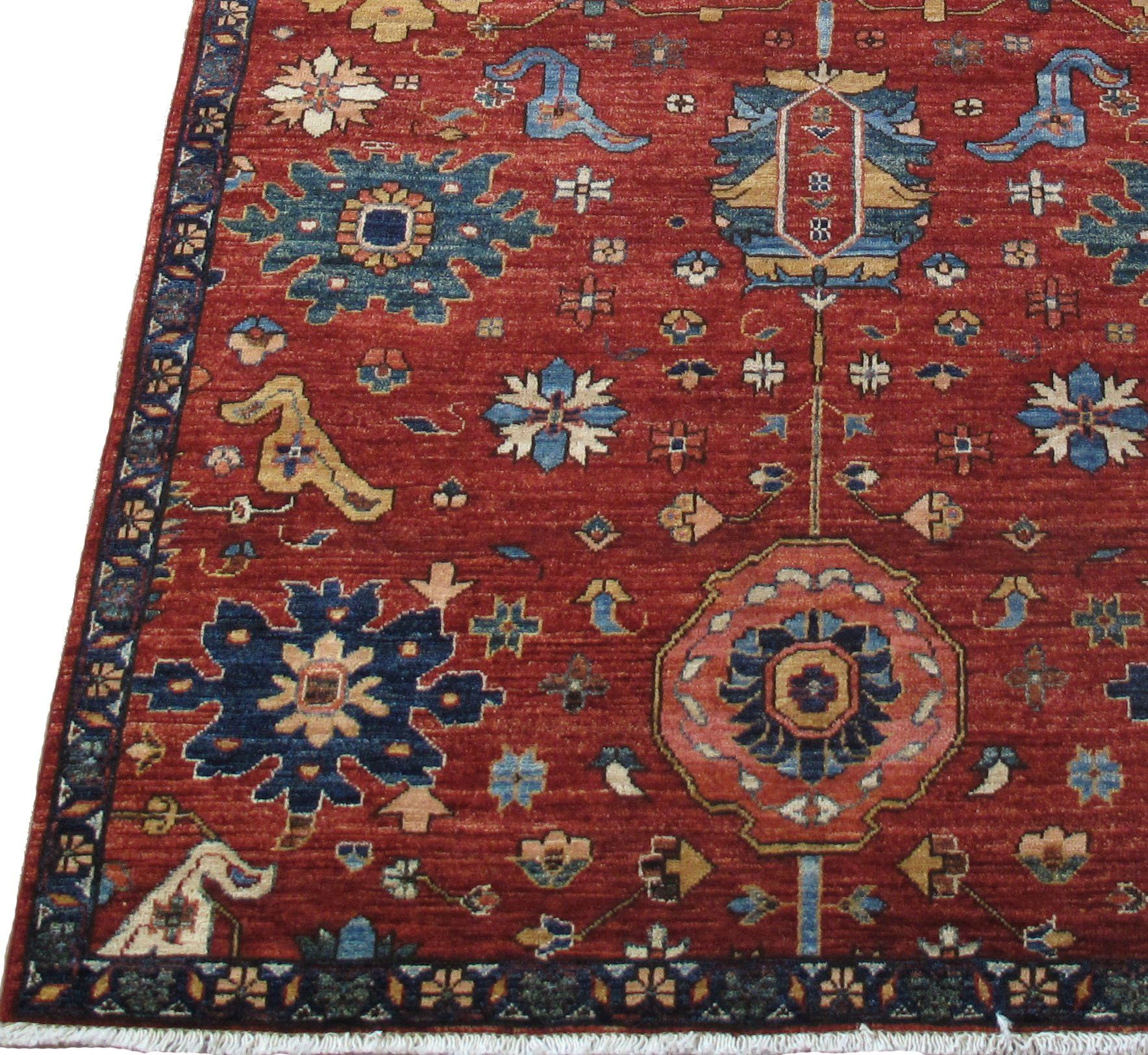 A red rug with a blue and yellow pattern on it