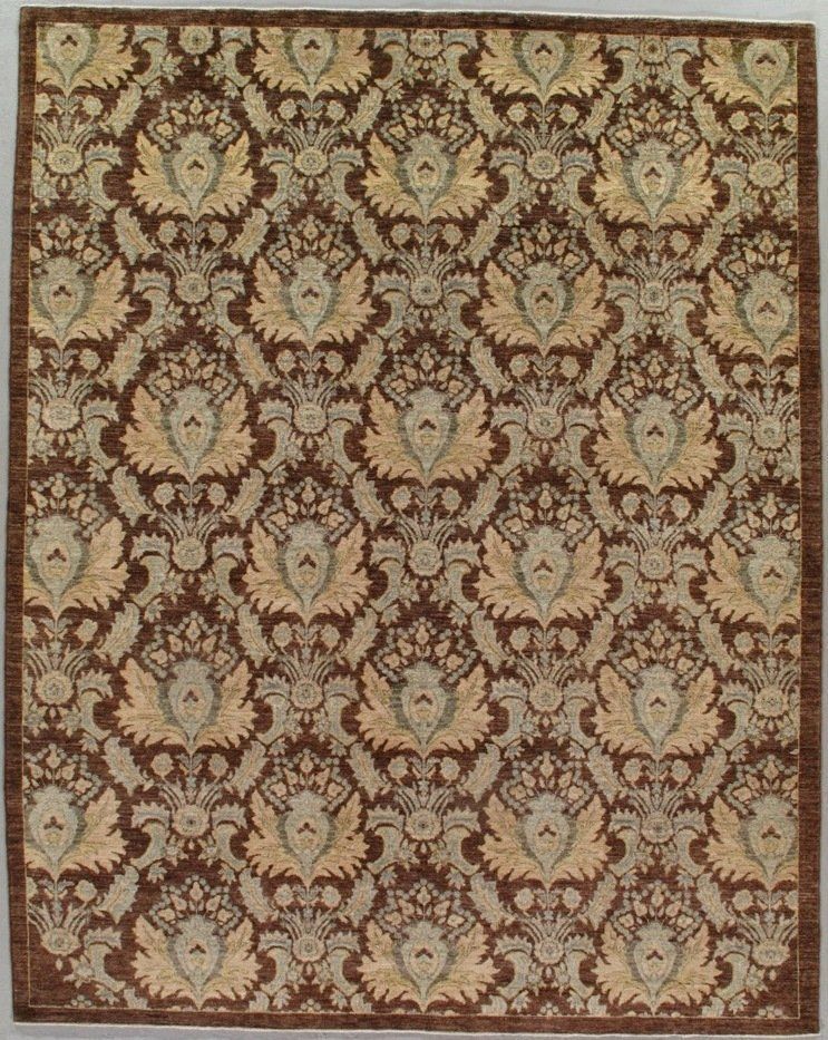A brown and tan rug with a floral pattern on it