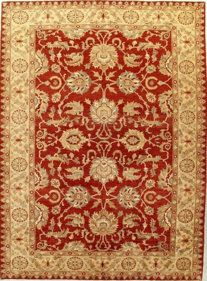 A red and tan rug with a floral pattern on it