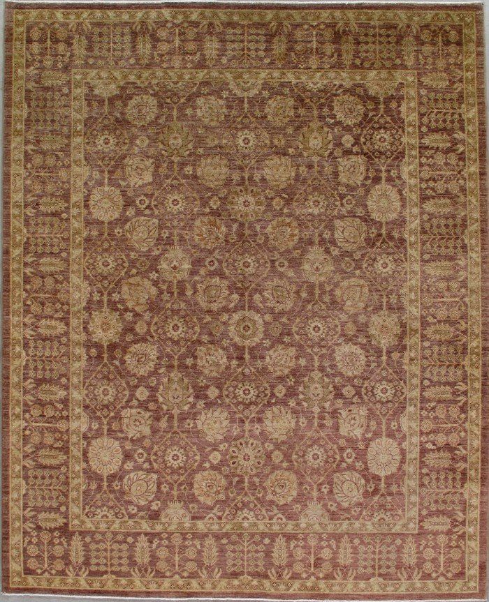 A brown and gold rug with a floral pattern on it