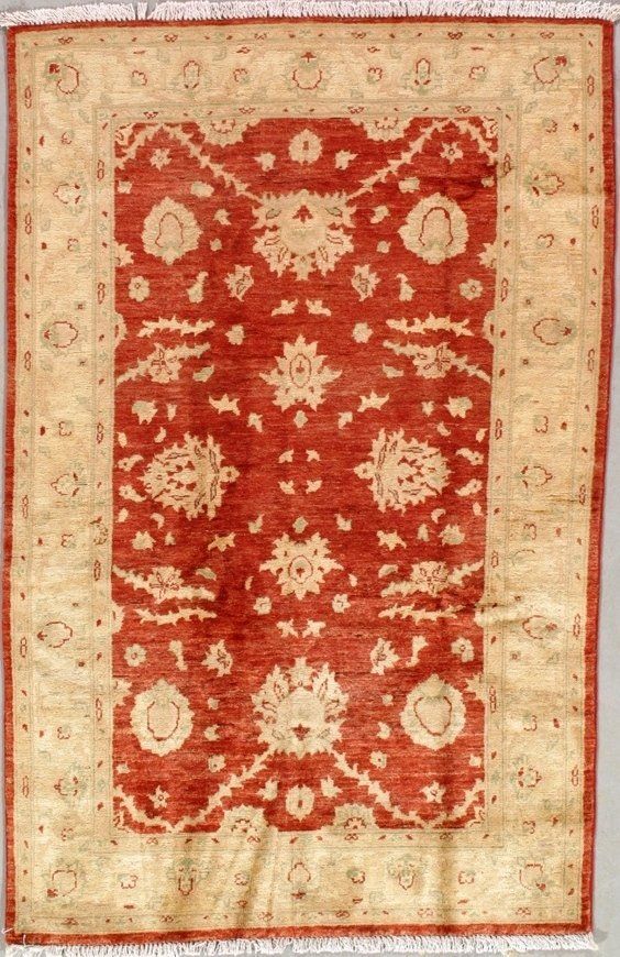 A red and white rug with a floral pattern on it