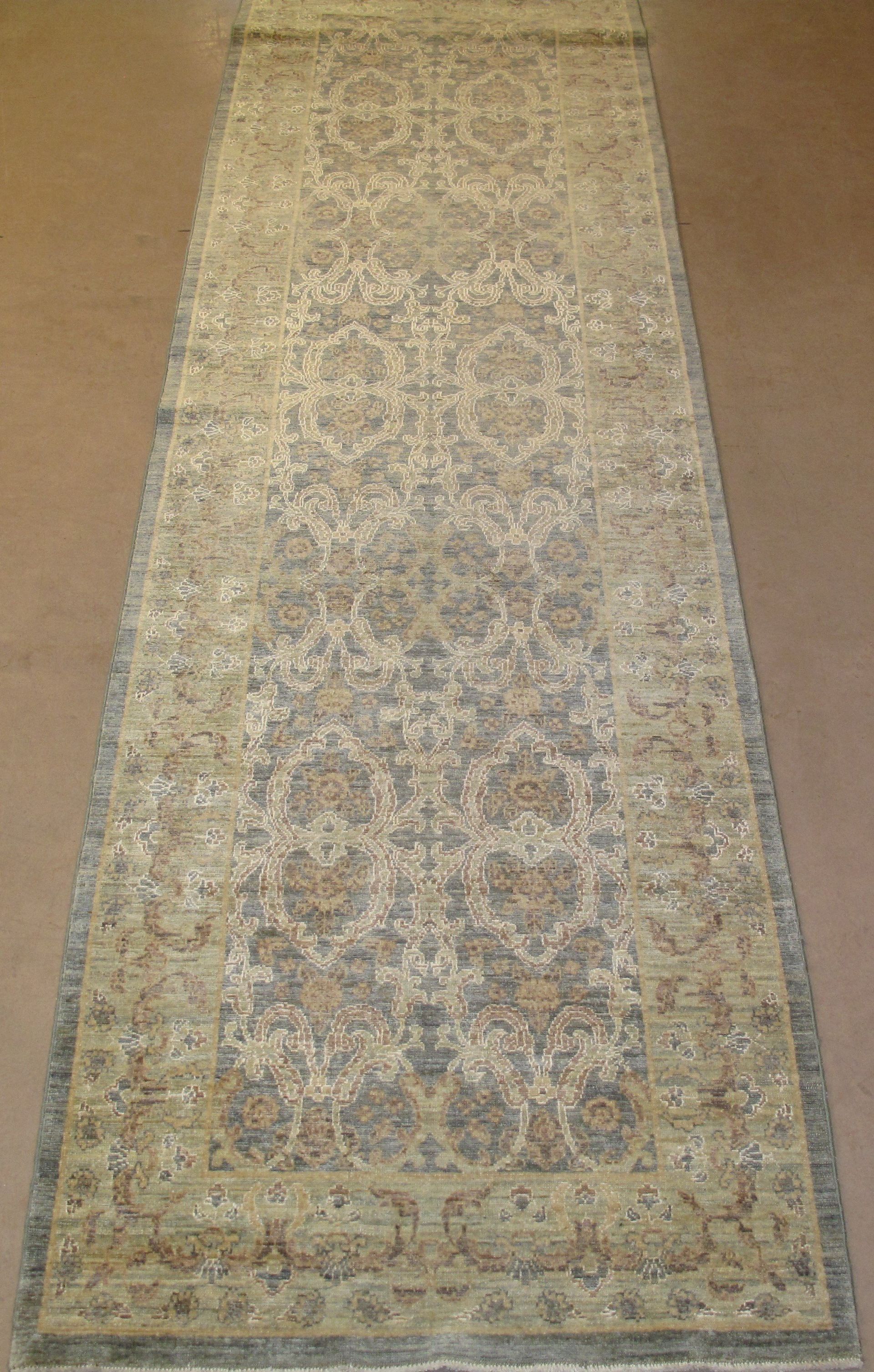 A rug with a pattern on it is sitting on a wooden floor.