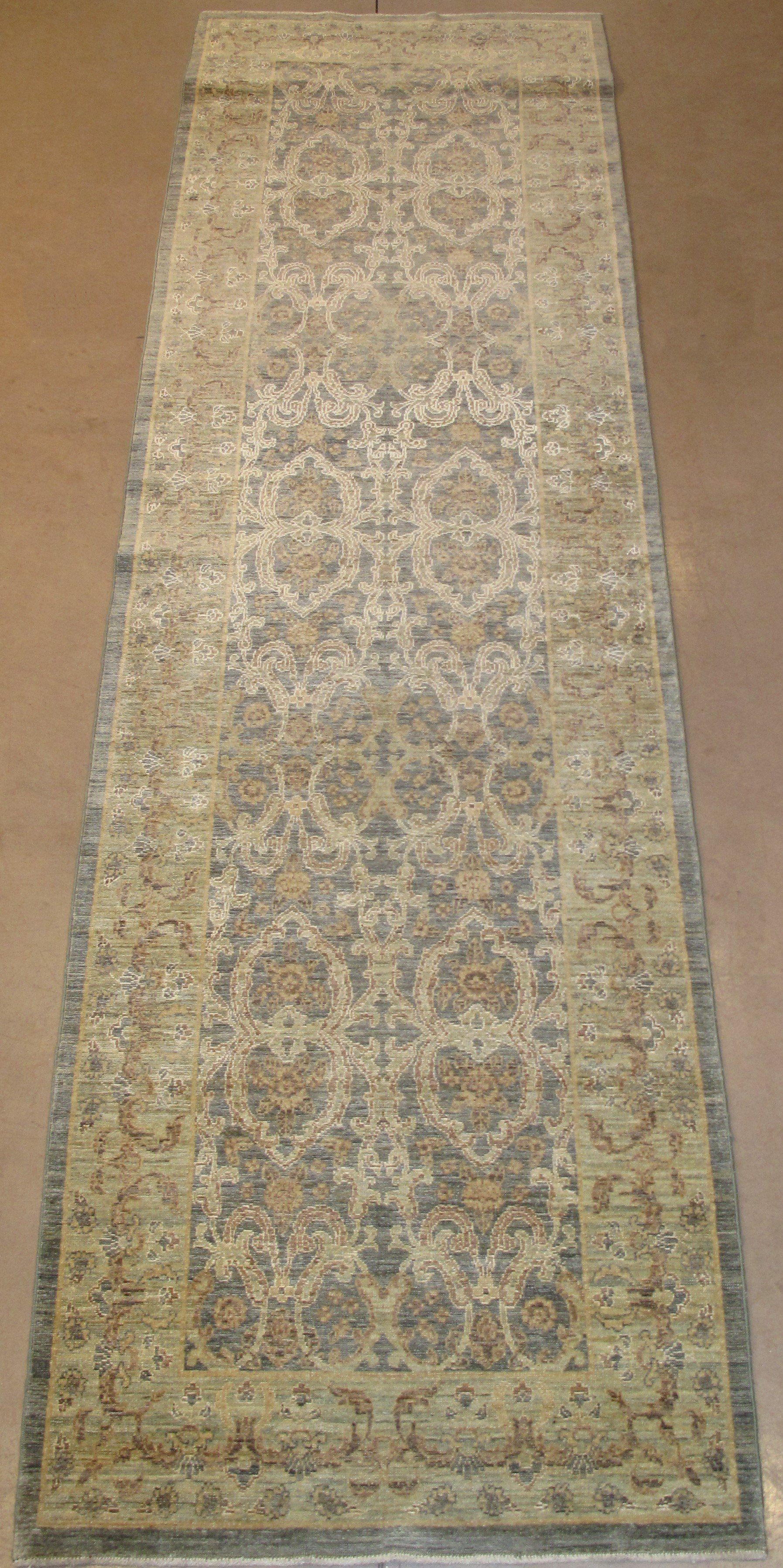 A rug with a pattern on it is sitting on a wooden floor.