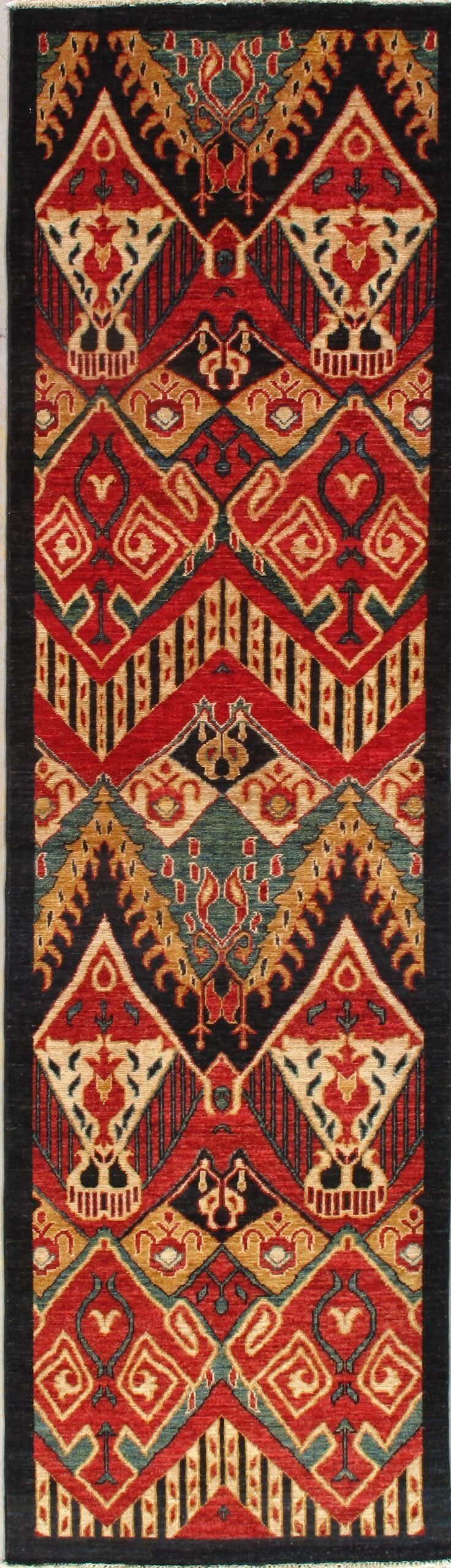 A rug with a geometric pattern on it is hanging on a wall.