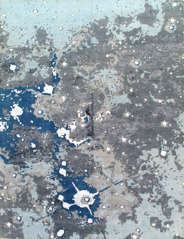 A close up of a gray and blue rug with white spots