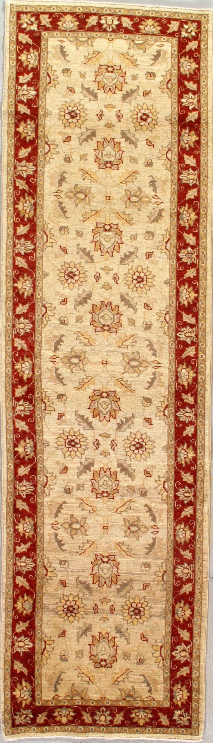 A white rug with a red border is sitting on a table.